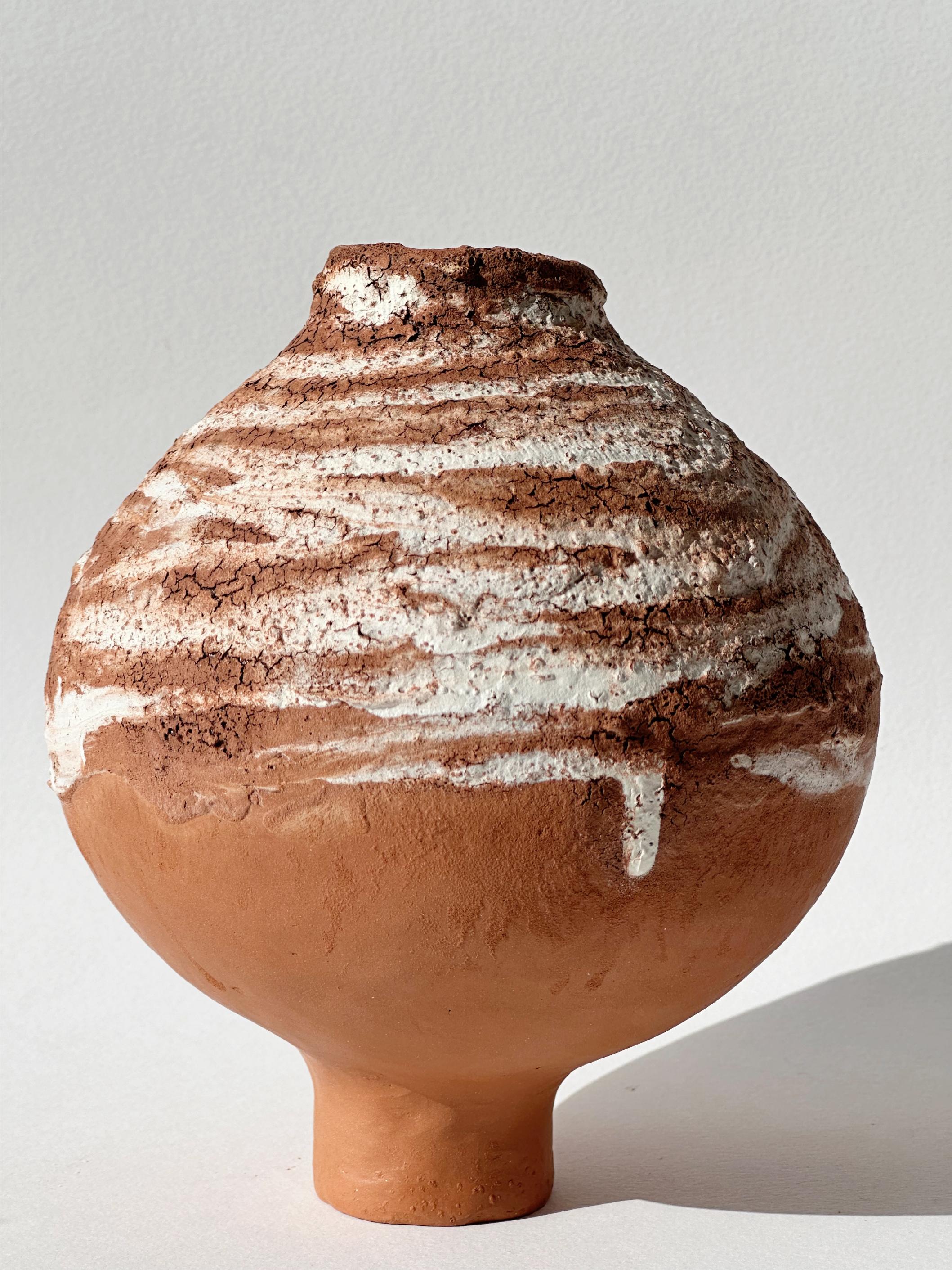 Terracotta Moon Jar No 17 by Elena Vasilantonaki
Unique
Dimensions: ⌀ 13.5 x H 16 cm (Dimensions may vary)
Materials: Local Terracotta Clay from the Island of
Crete

Growing up in Greece I was surrounded by pottery forms that have changed little