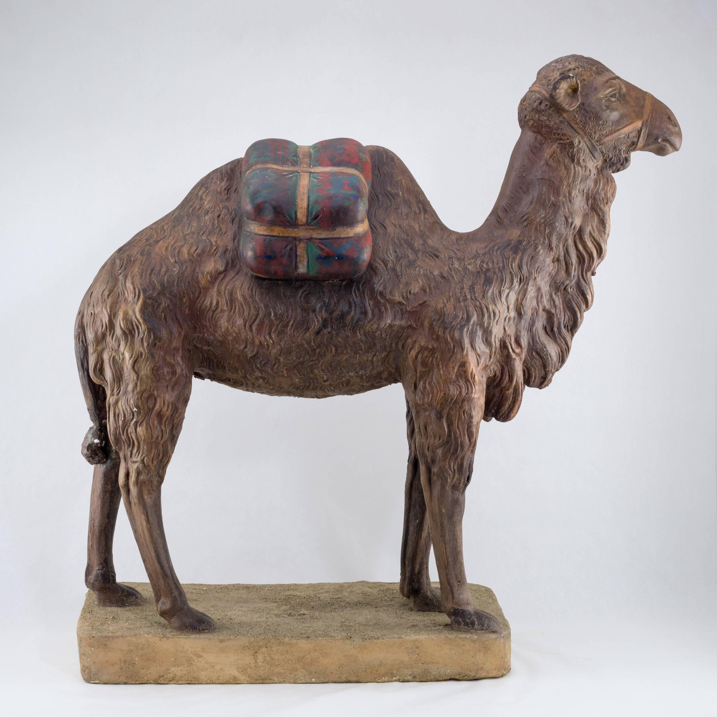 Terracotta polychromed figure of a camel
Finely detailed, standing on sand style
terracotta plinth.
American, circa 1940
$2500.
  