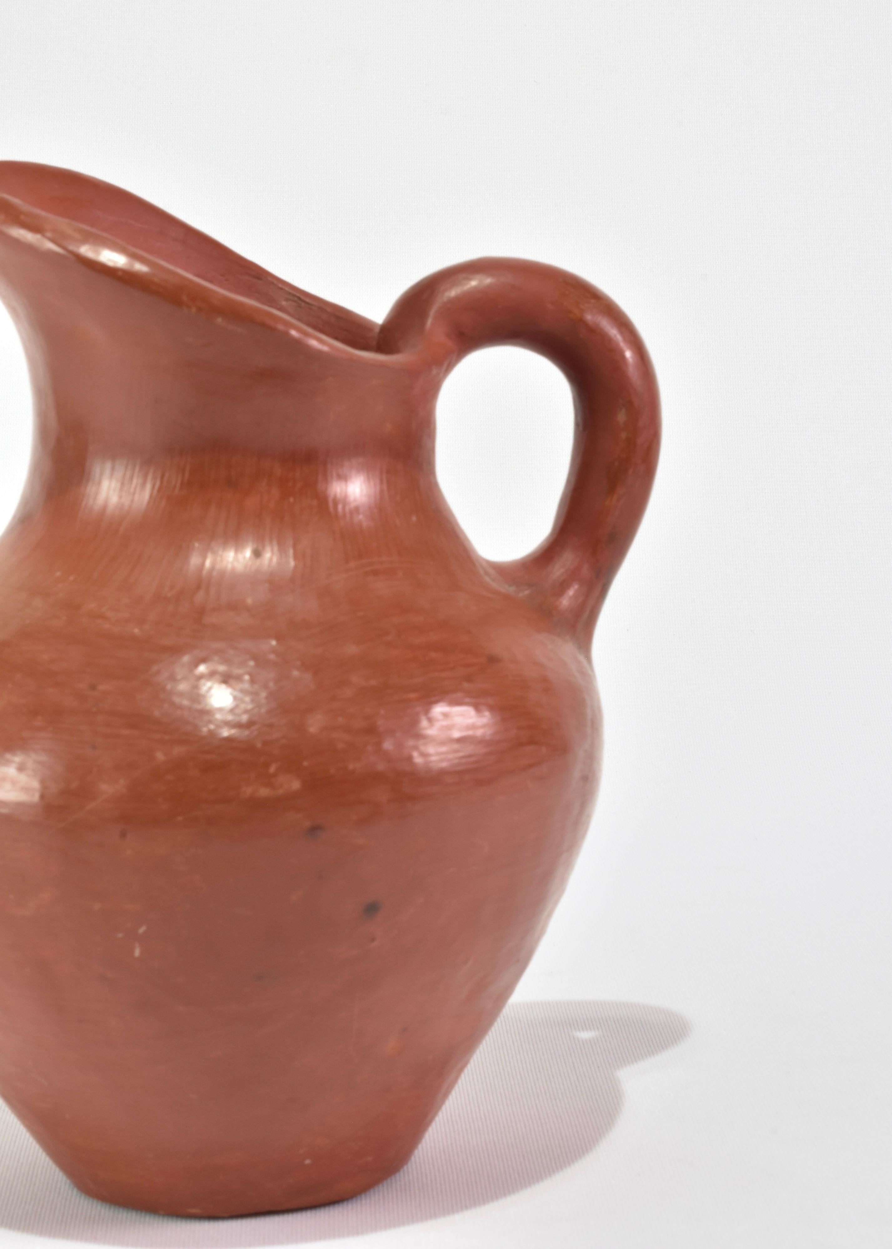 Vintage handmade terracotta pitcher. Display on its own as a sculptural piece or add a dried floral arrangement.