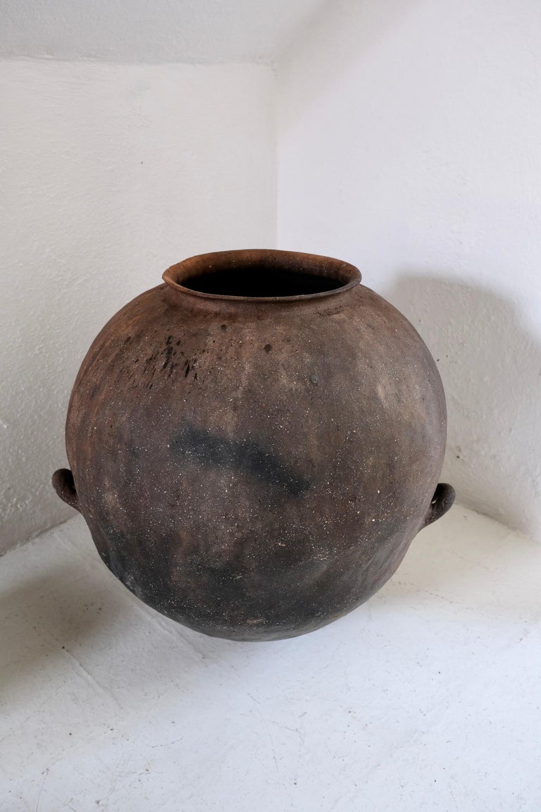Terracotta water jar from the northern sierras of Puebla, hand crafted by the indigenous Nahua people, circa 1920's. Originally used for storing water from nearby rivers. This style of pottery is now scarce. The general shape of the vessel as well