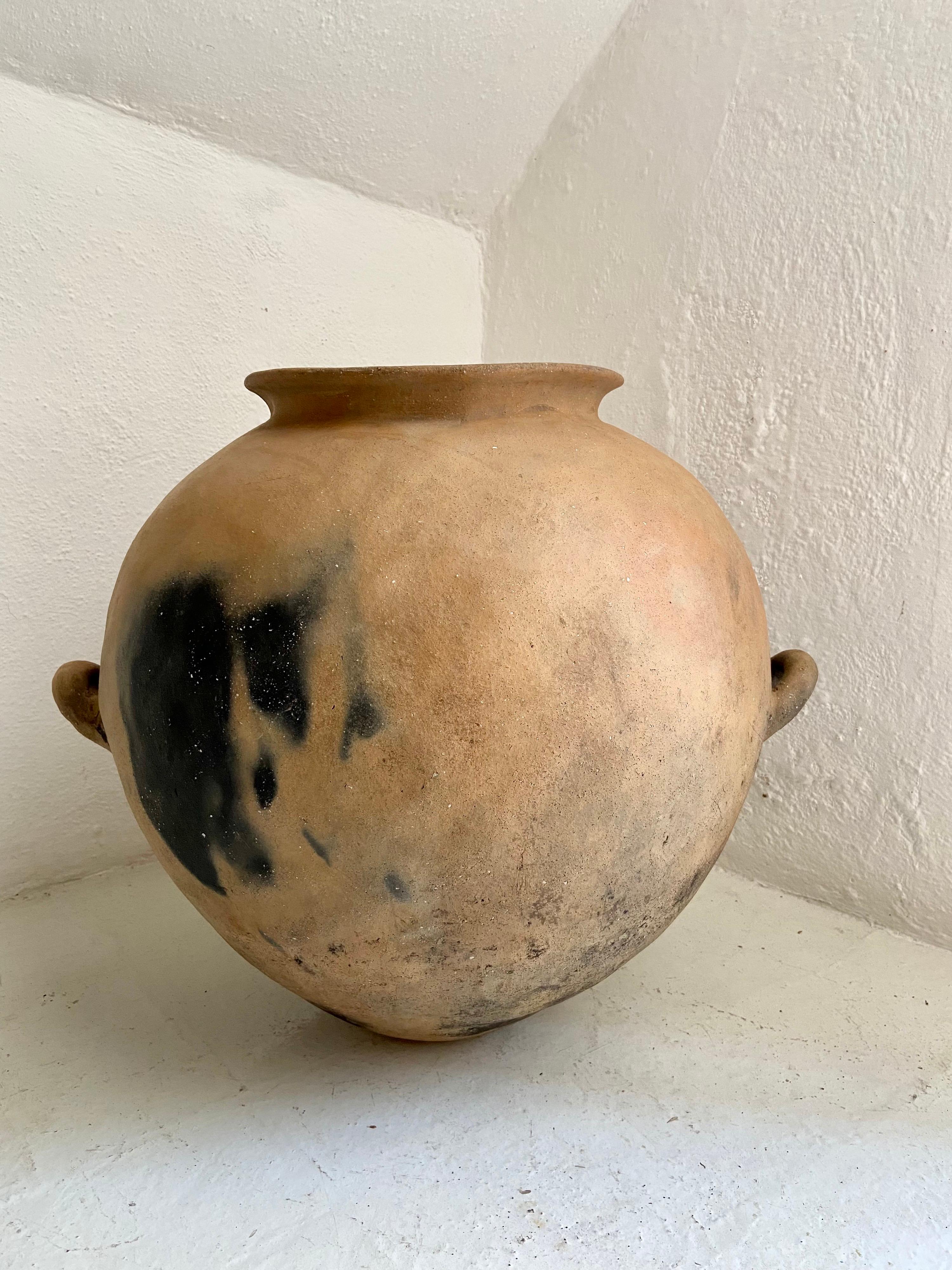 Terracotta pot with handles from Mexico, Early 20th century. Hand-coiled by the Nahua indigenous people of the Northwestern region of Puebla. This style of pottery was discontinued over 60 years ago.