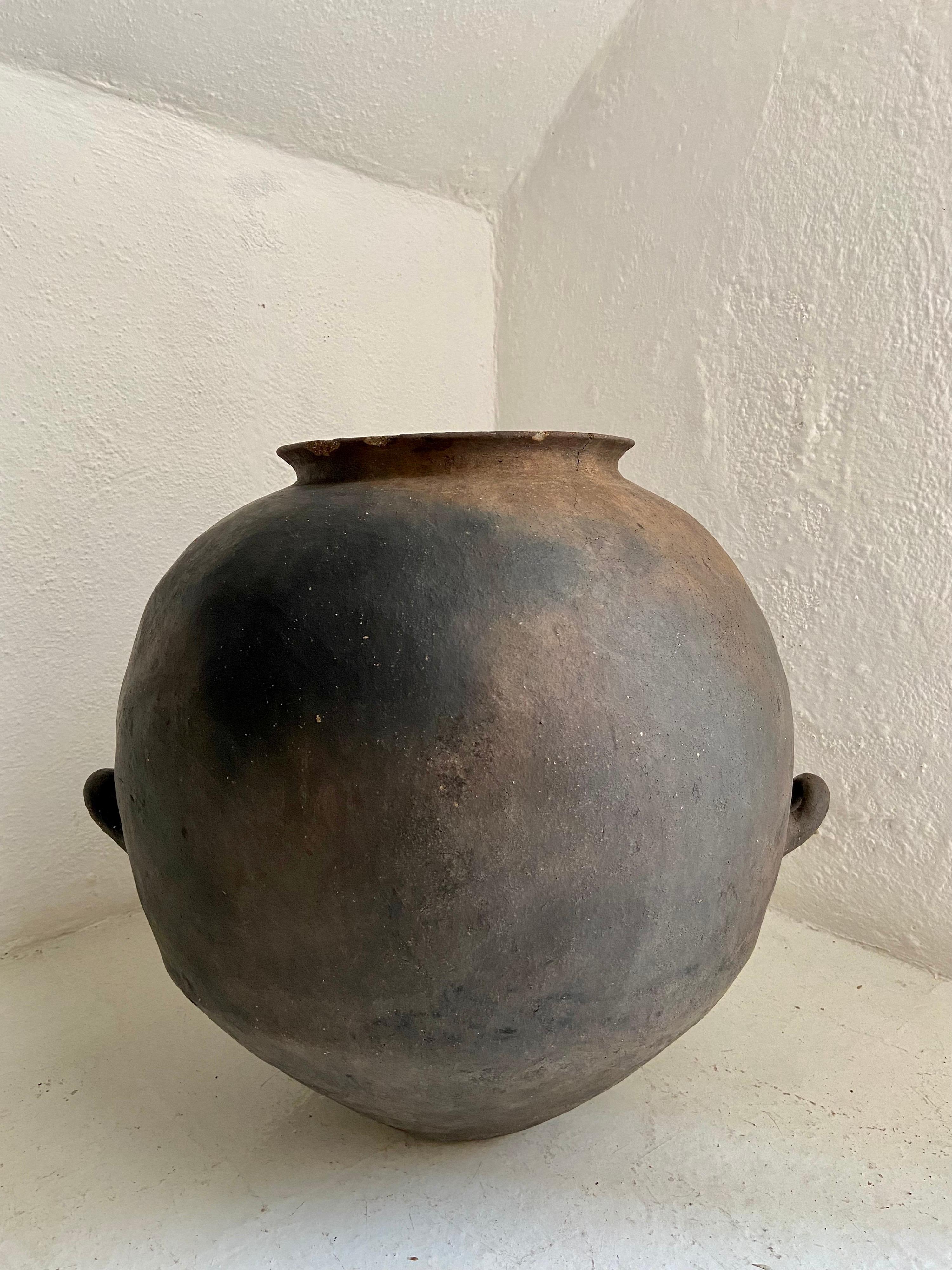 Hand-coiled terracotta water pot with support handles from the Nahua indigenous people of Northwestern Puebla, Early 20th Century. This style of pottery was discontinued over 60 years ago with the introduction of plastics.