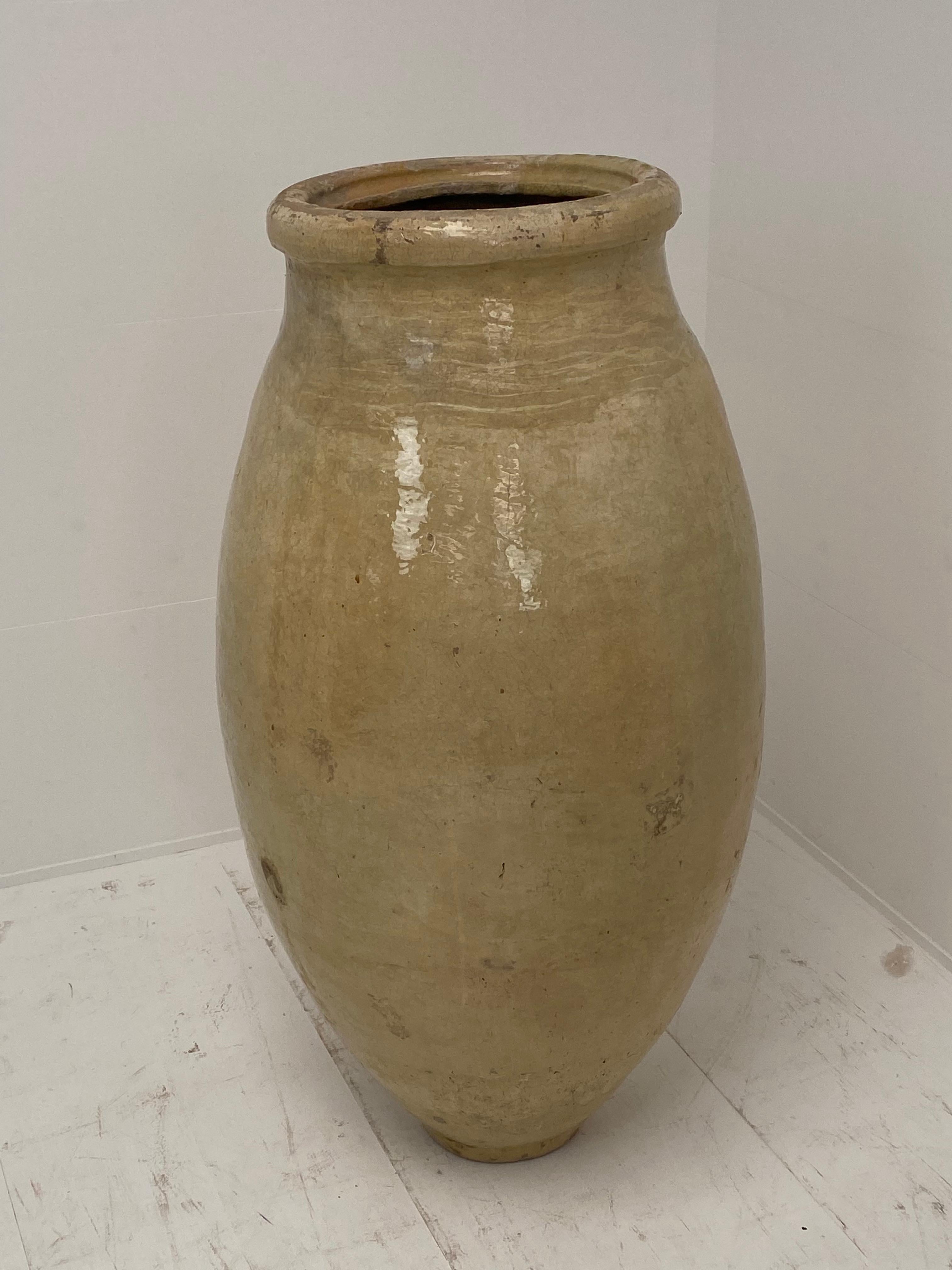 Terracotta Pot/Jar in a beautiful Cream Glazed color,
From Spain,La Bisbal De Emporda, 
comes with his original Iron stand,
great patina,1920,
total height with iron stand is 108 cm,
to be used as well inside as outside