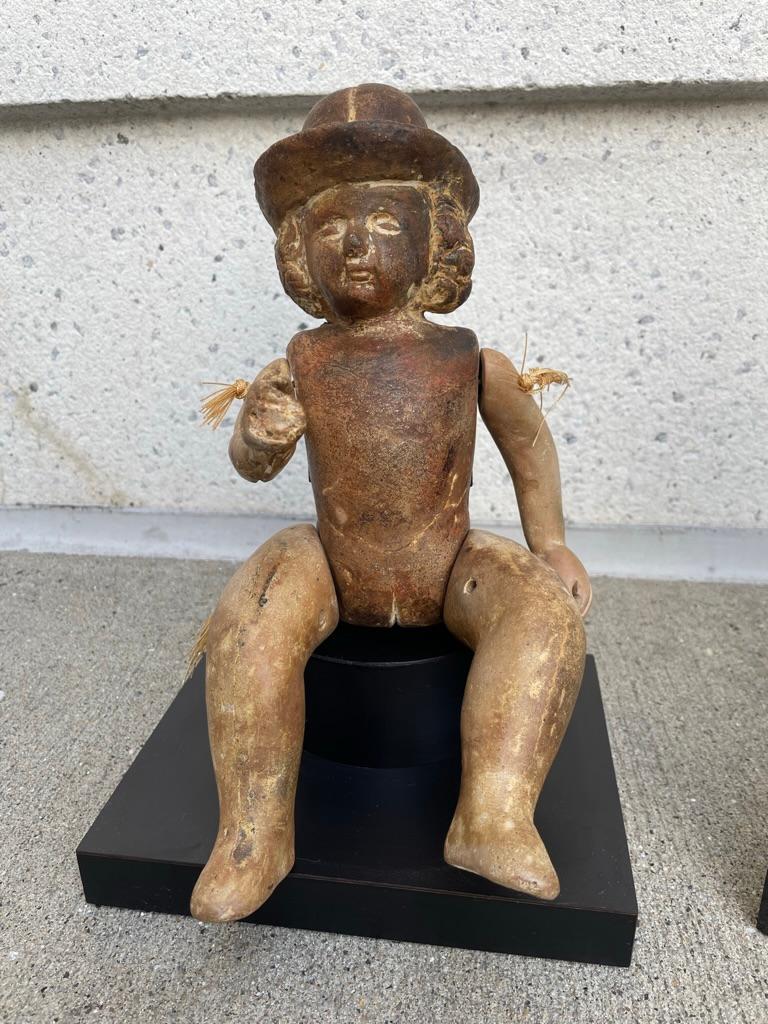 Unusual, and quite amusing Mexican terracotta doll figure with articulated limbs. Since it is solid terracotta it is likely this is a mold from which other dolls were made. As a folk art sculpture it is absolutely charming. 
The bowler hat gives it