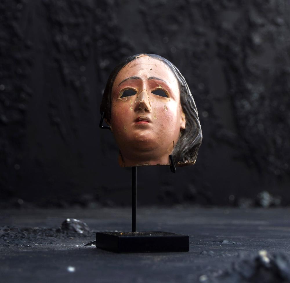 A rare 19th century terracotta Santos mask/fragment on a bespoke display stand.

This religious, macabre artefact would likely have been a part of a full Santos statue which would have sat in religious bay window or hall of a church in Belgium.