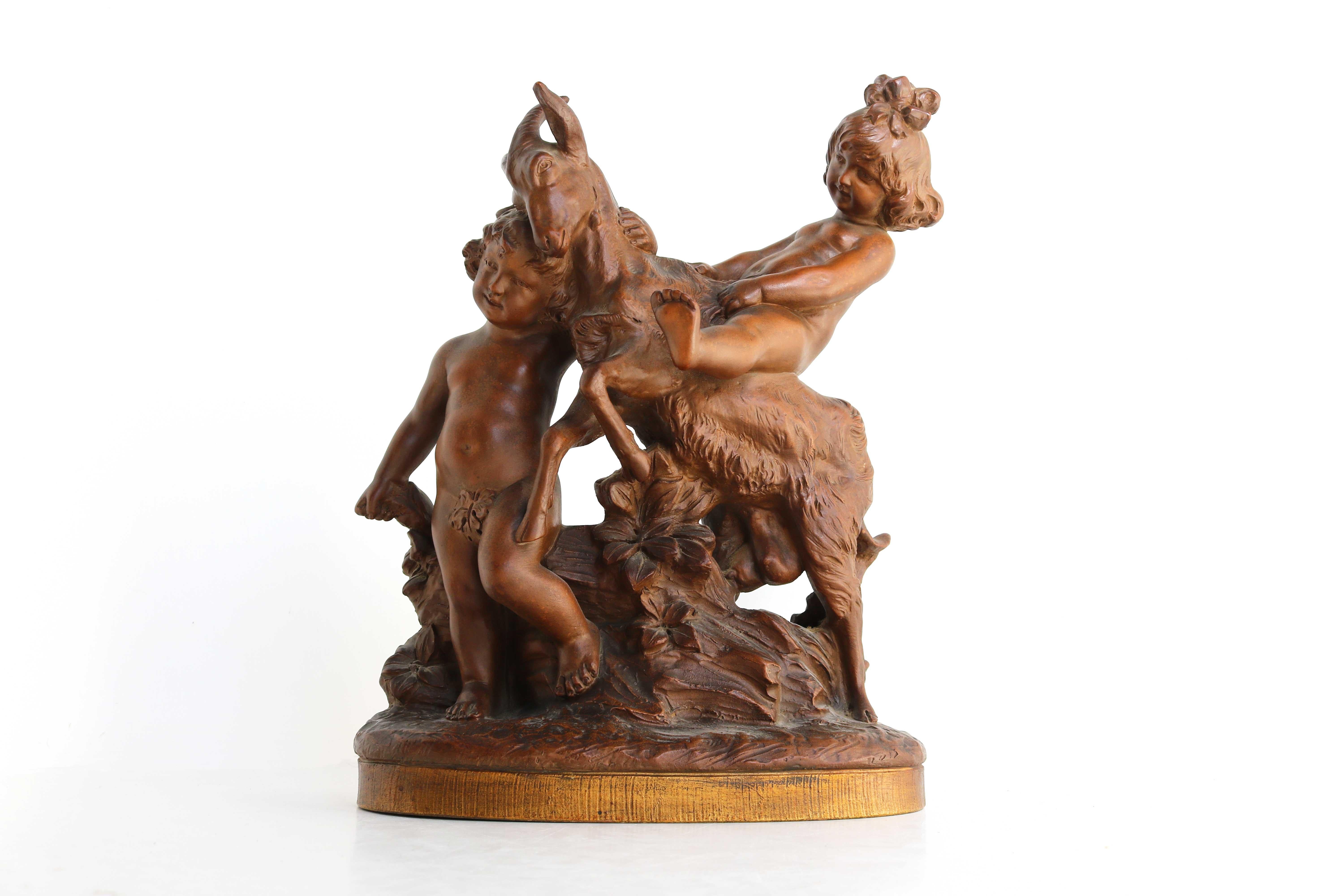 Terra Cotta Group Boy And Girl Playing With A Goat After Pietro Balestra 1900s
Late 19th century beautifully detailed statue in terracotta of a boy and a girl playing with a goat placed on an oval, delicately gilded base, decorated with grooves.