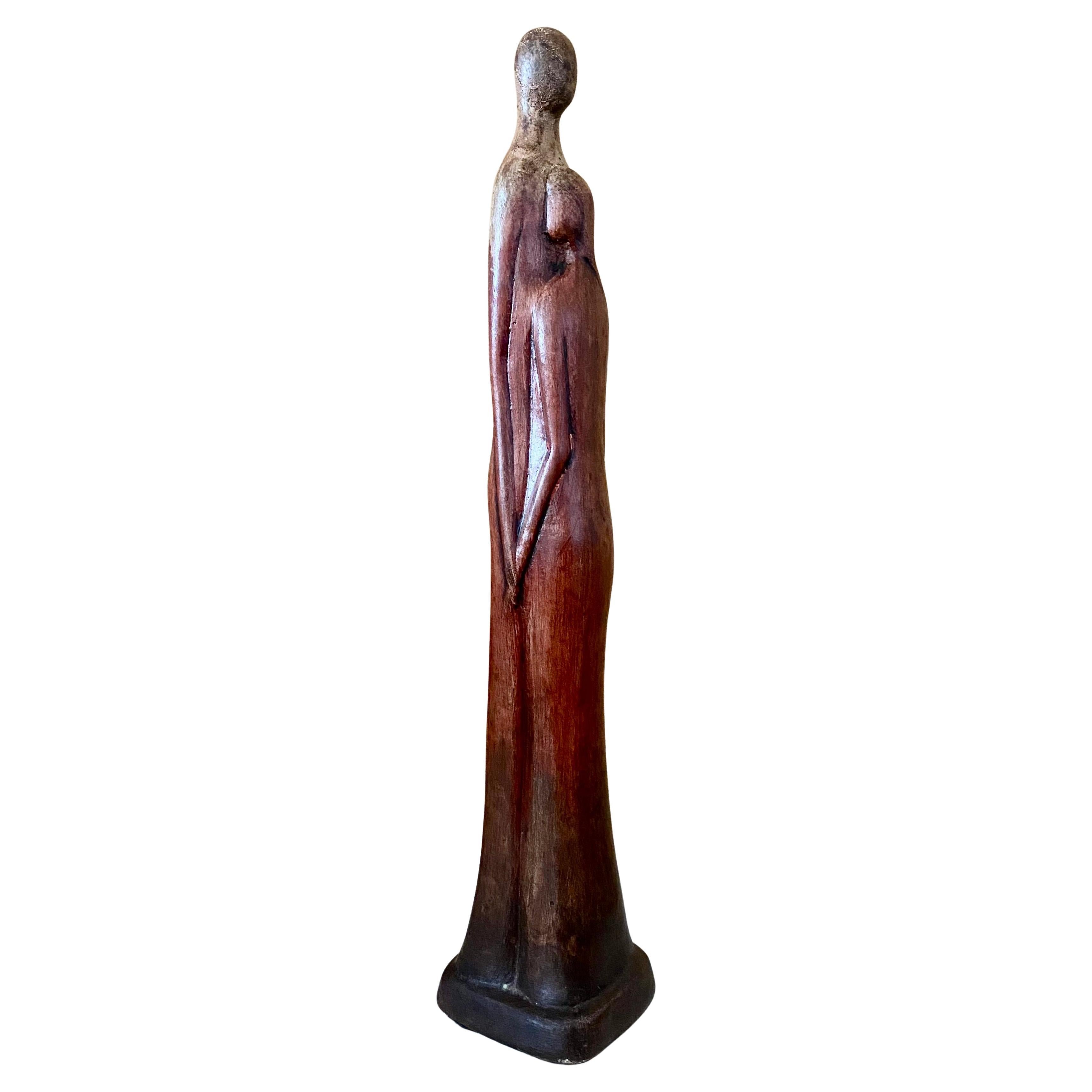 DA tall, slim terra cotta sculpture featuring two figures in an embrace. Wonderful rust finish over entire surface; illegibly signed to base. Large-scale piece that creates a dramatic centerpiece. 

Hefty, thick, hand-sculpted terra cotta
