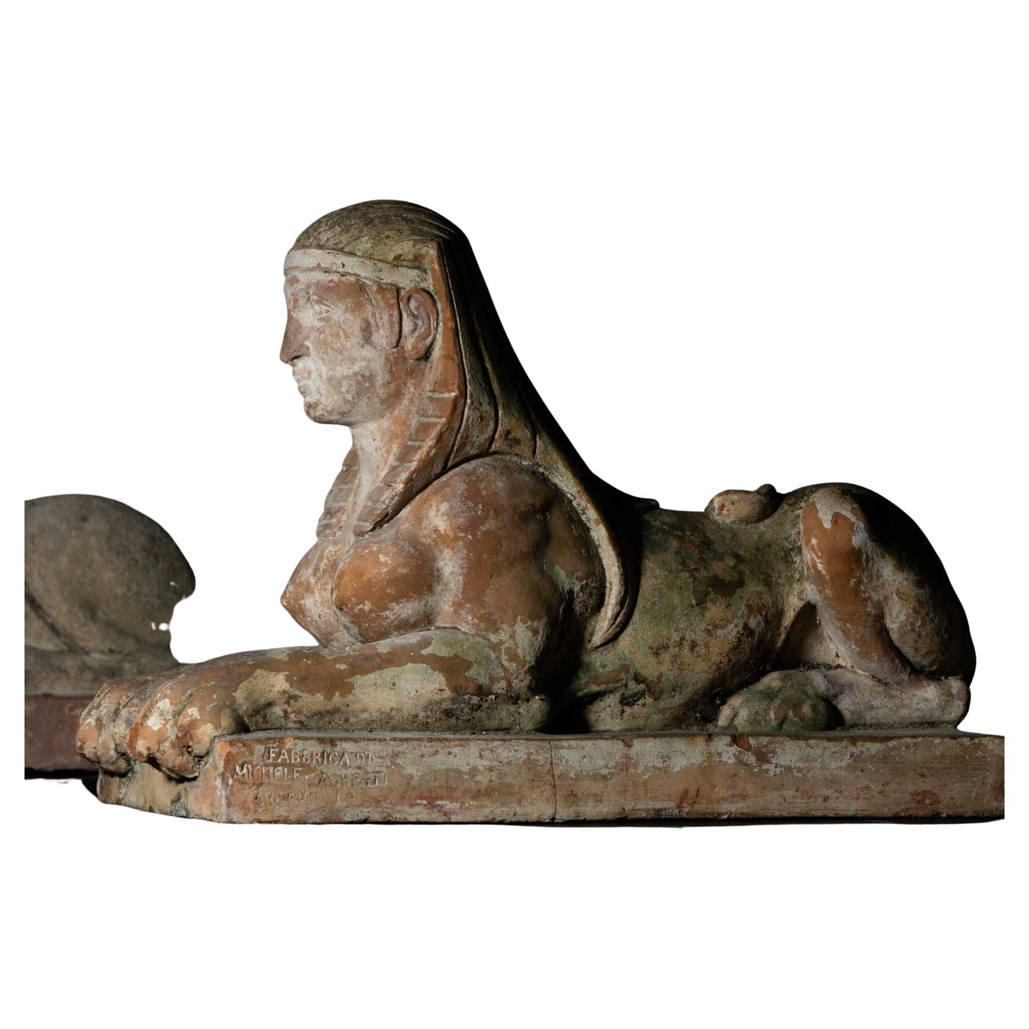 Pair of Italian terracotta sphinxes in the Egyptian style. Each sphinx is stamped on the side: Fabbricato Michele Agresti, Firenze. Unrestored patina condition. The Agresti family is a well-known pottery family from Tuscany, active since the 17th