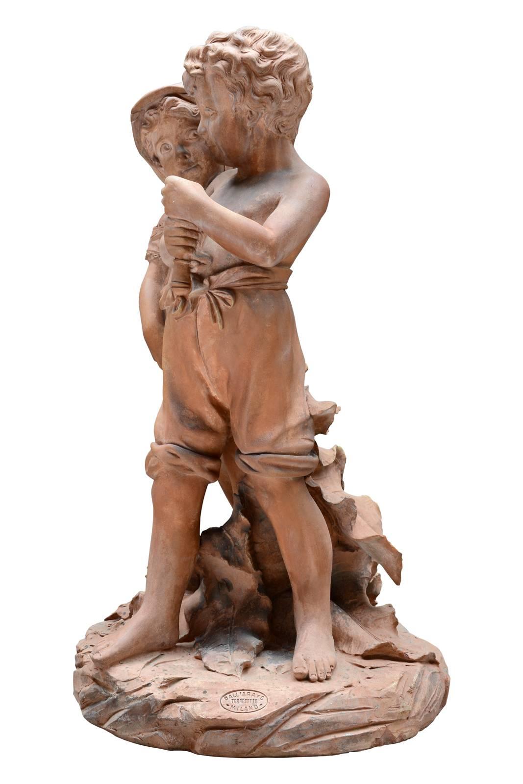 Terracotta statue dated from the 19th century, circa 1890 and depicting two children tight against each other under what should have been an umbrella, indeed the little boy holds tightly in his hands a handle. The two children dressed poorly and