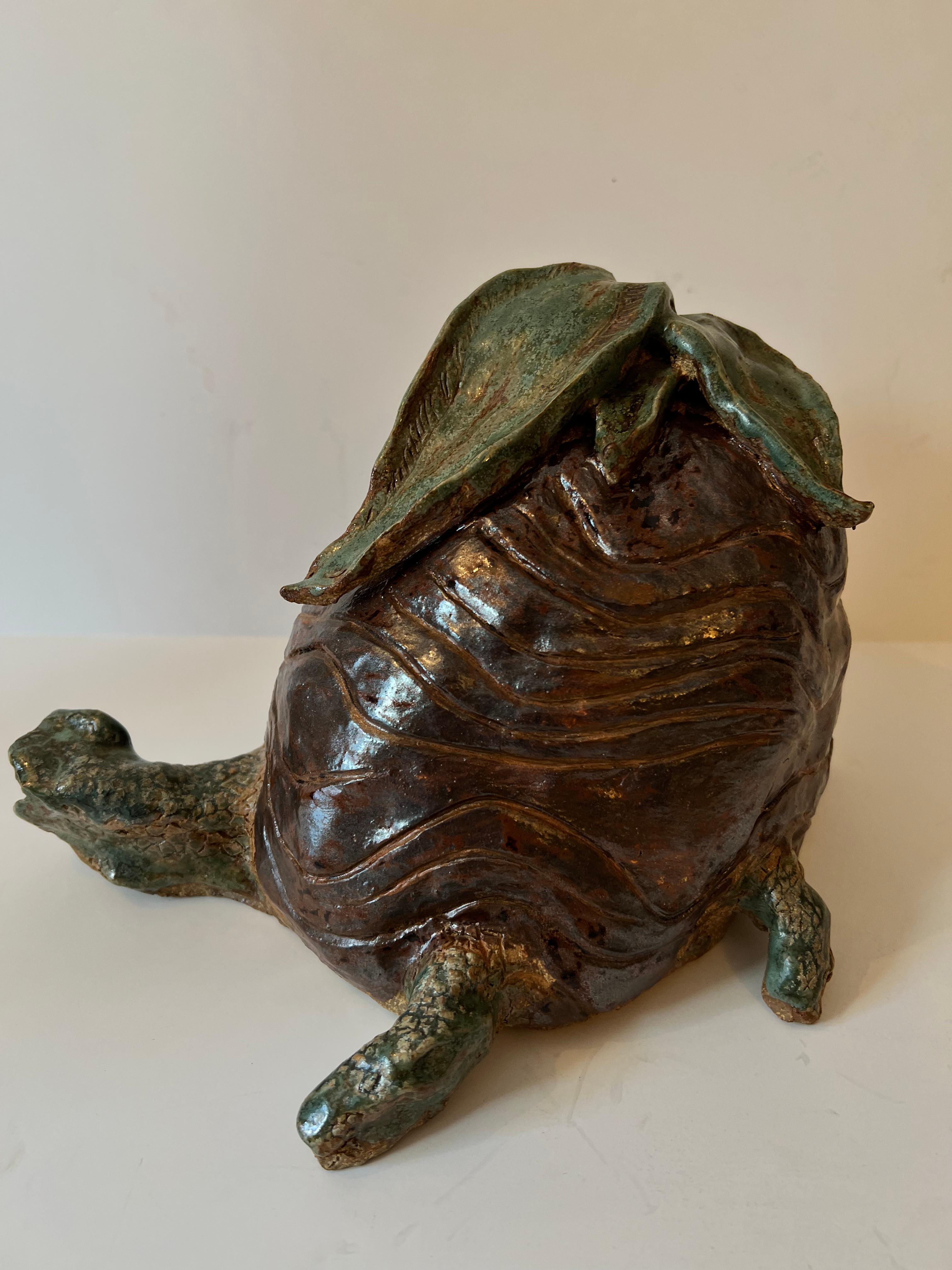 A hand made studio pottery turtle. The piece is quite unique and would make a perfect decorative item in many rooms, especially the Childs room or garden area. The piece is also sturdy and heavy enough to be a door stop.