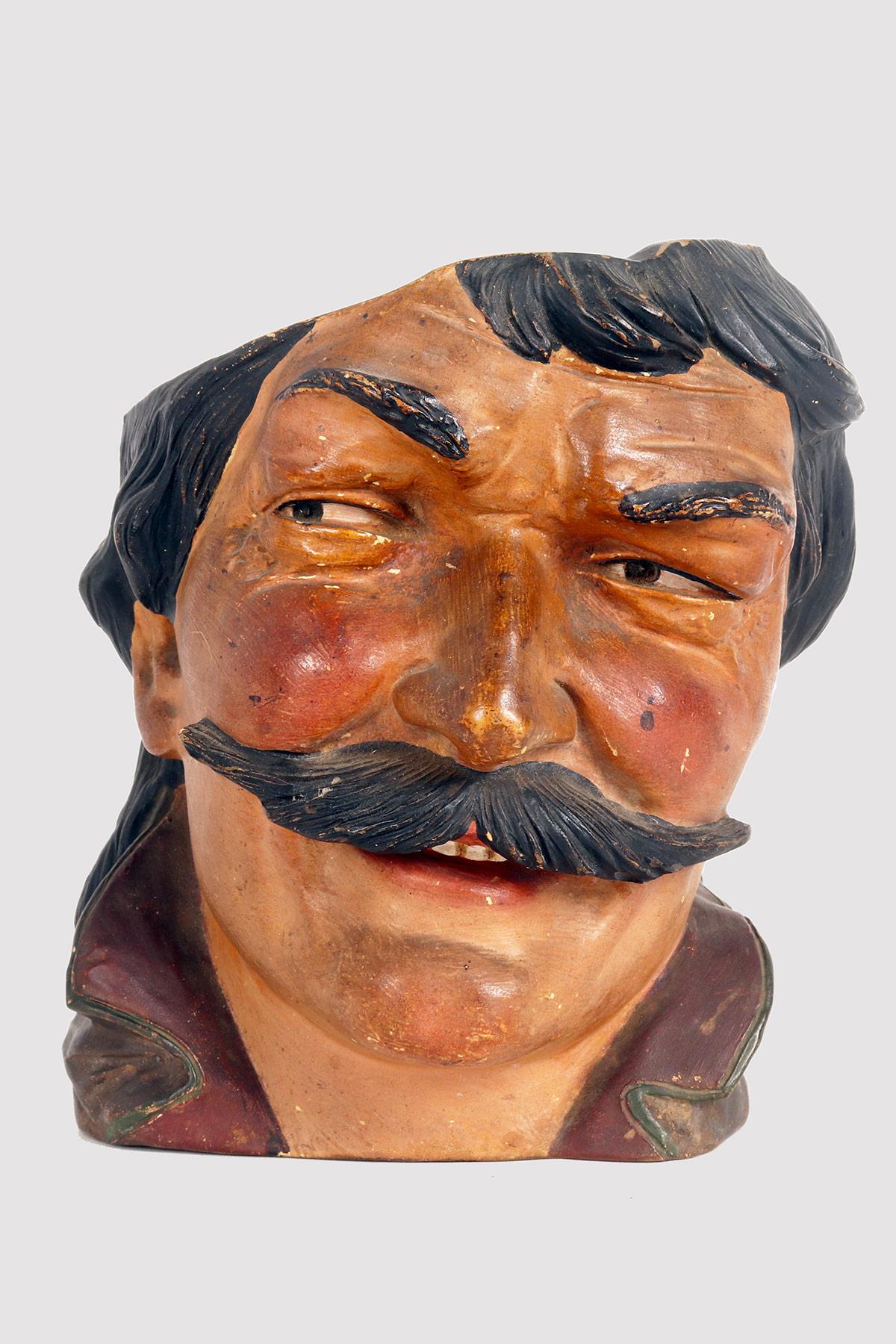 Terracotta vase finished in color depicting the head of a man with mustache. Austria, around 1890.
