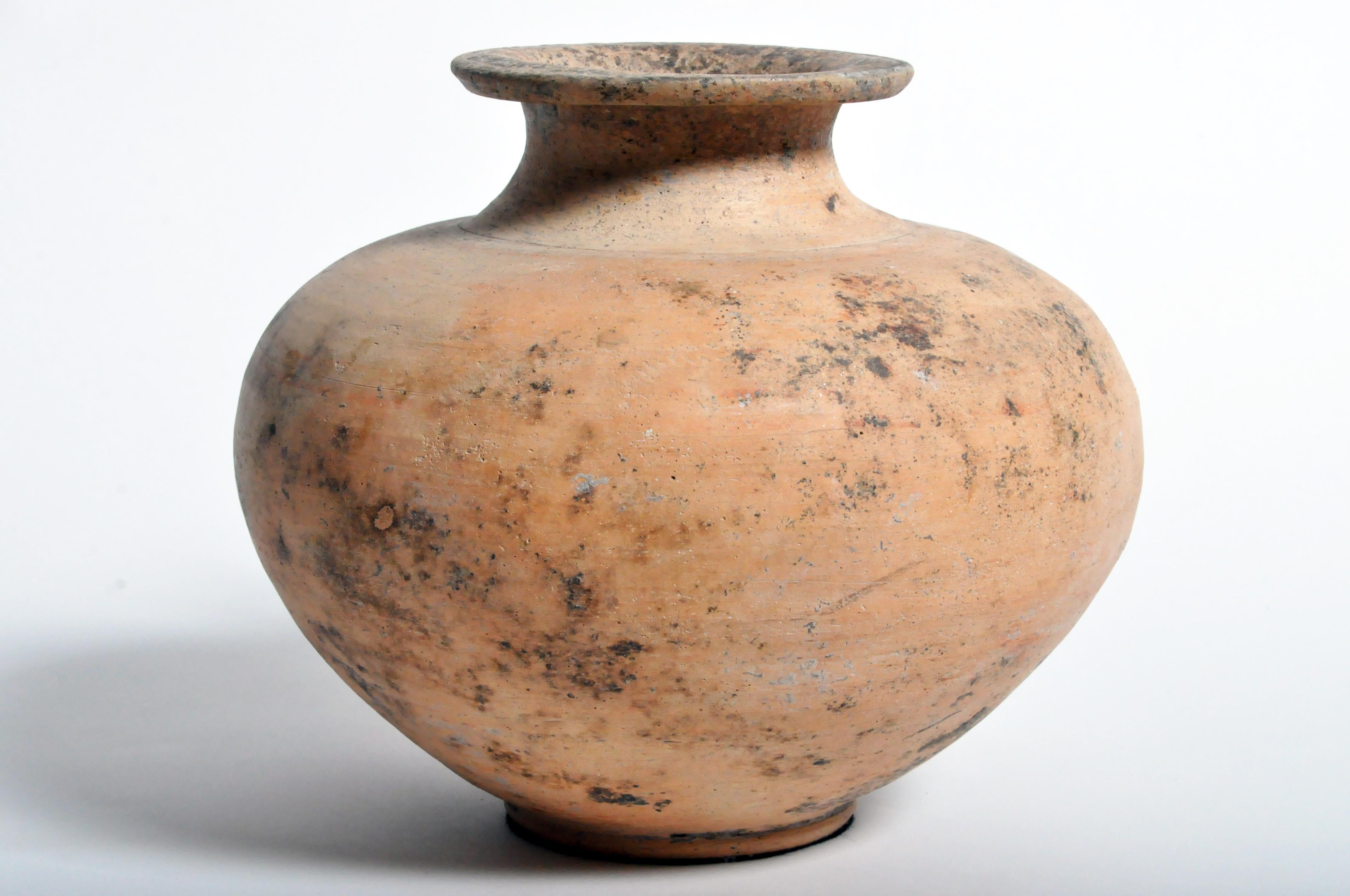 This terracotta vessel is a new piece based on an old Northern Thai pattern. It was turned on a potter’s wheel and the molded spout added on.
      