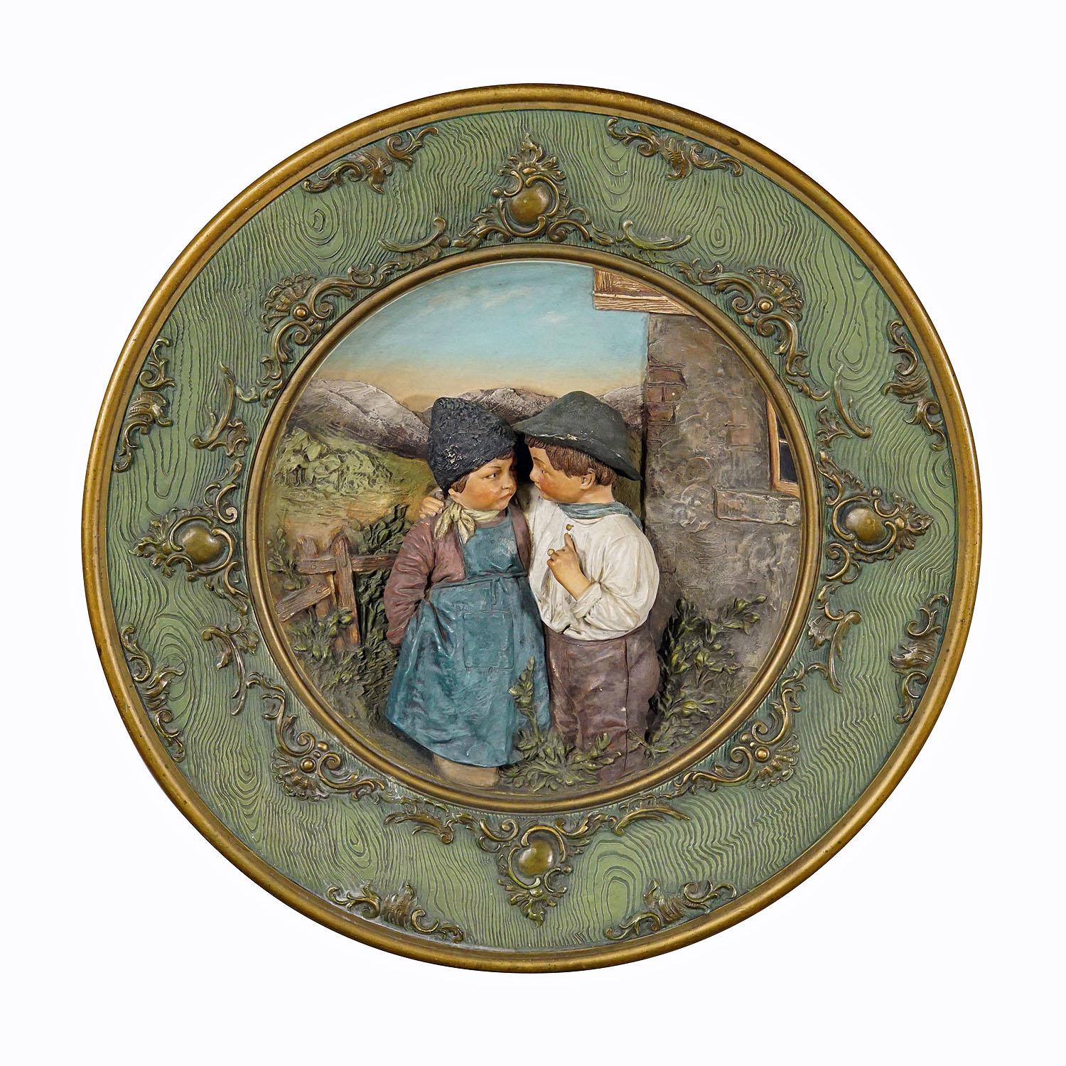 Terracotta Wall Plate with Lovely Children in Traditional Costumes by Johann Maresch

A large terracotta wall plate depicting a relief couple of farmers childs in a rural enviroment. Manufactured by Johann Maresch, Aussig Austria in the late 19th