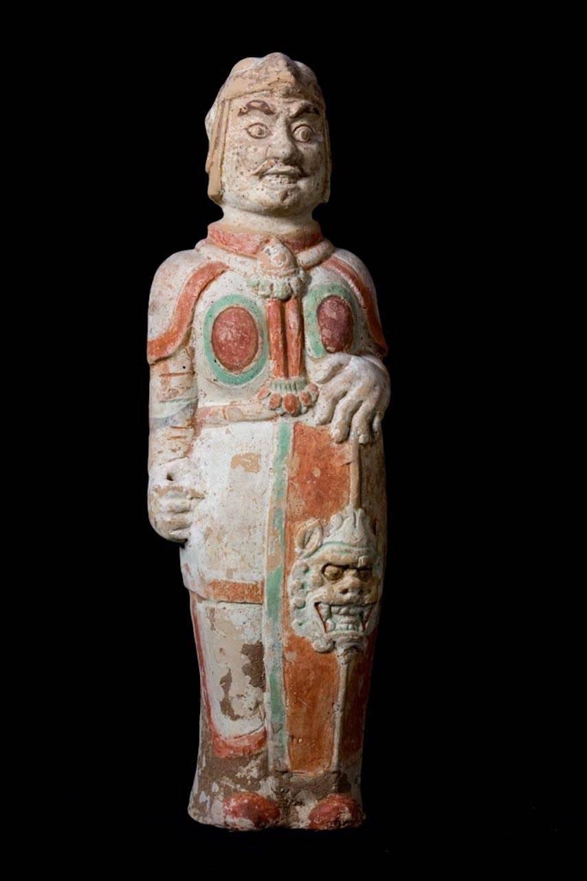 Standing terracotta warrior with traces in orange, green and white painting, wearing a helmet and holding a lion's mask shield.

Northern Wei Dynasty: 386-557 AD

This magnificent piece is accompanied by a European Passport, a Certificate of