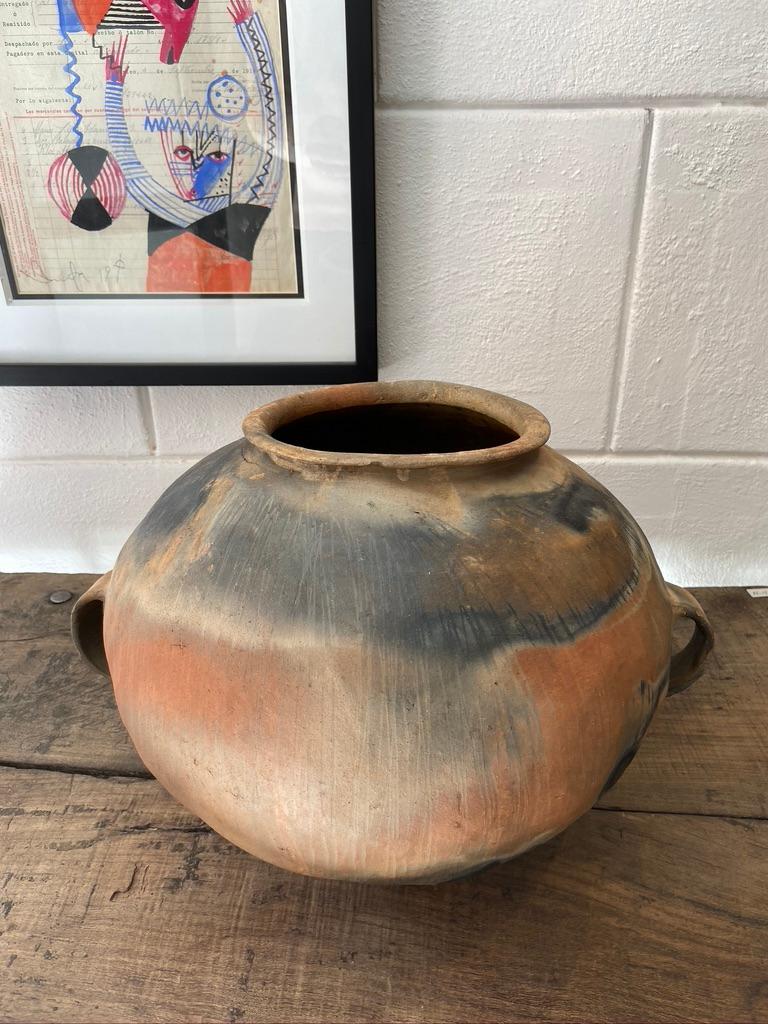 Terracotta water pot indigenous to the Nahua people of Puebla's northern sierra mountain range. Unusual fire markings. This piece was completely cleaned stripping away years of grit.