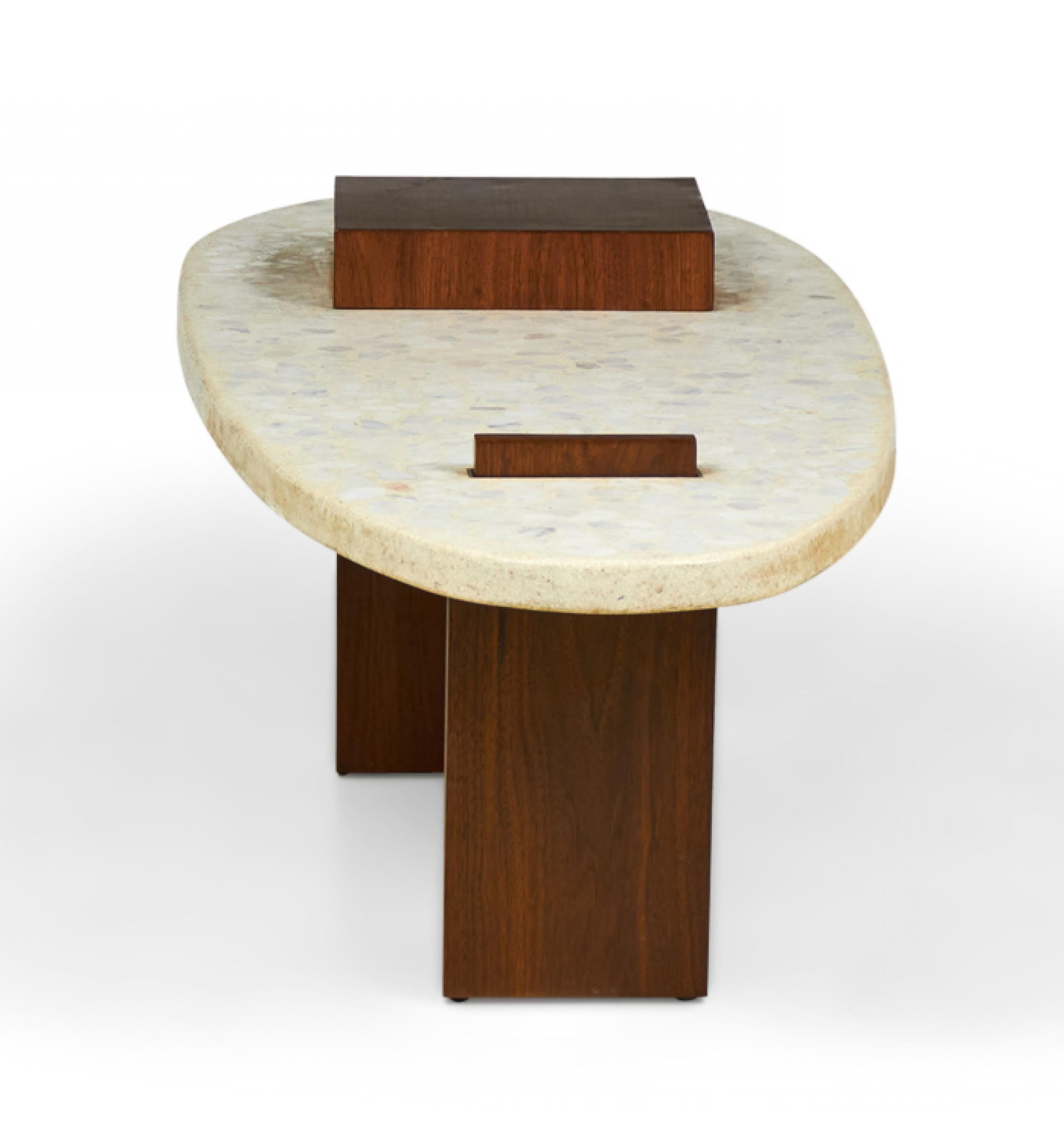 American Mid-Century (circa 1950) sculptural cocktail / coffee table with a tapered oval terrazzo top reminiscent of a surfboard and walnut 'post' and 'fin' legs that support and pierce the table surface. (manner of HARVEY PROBBER).