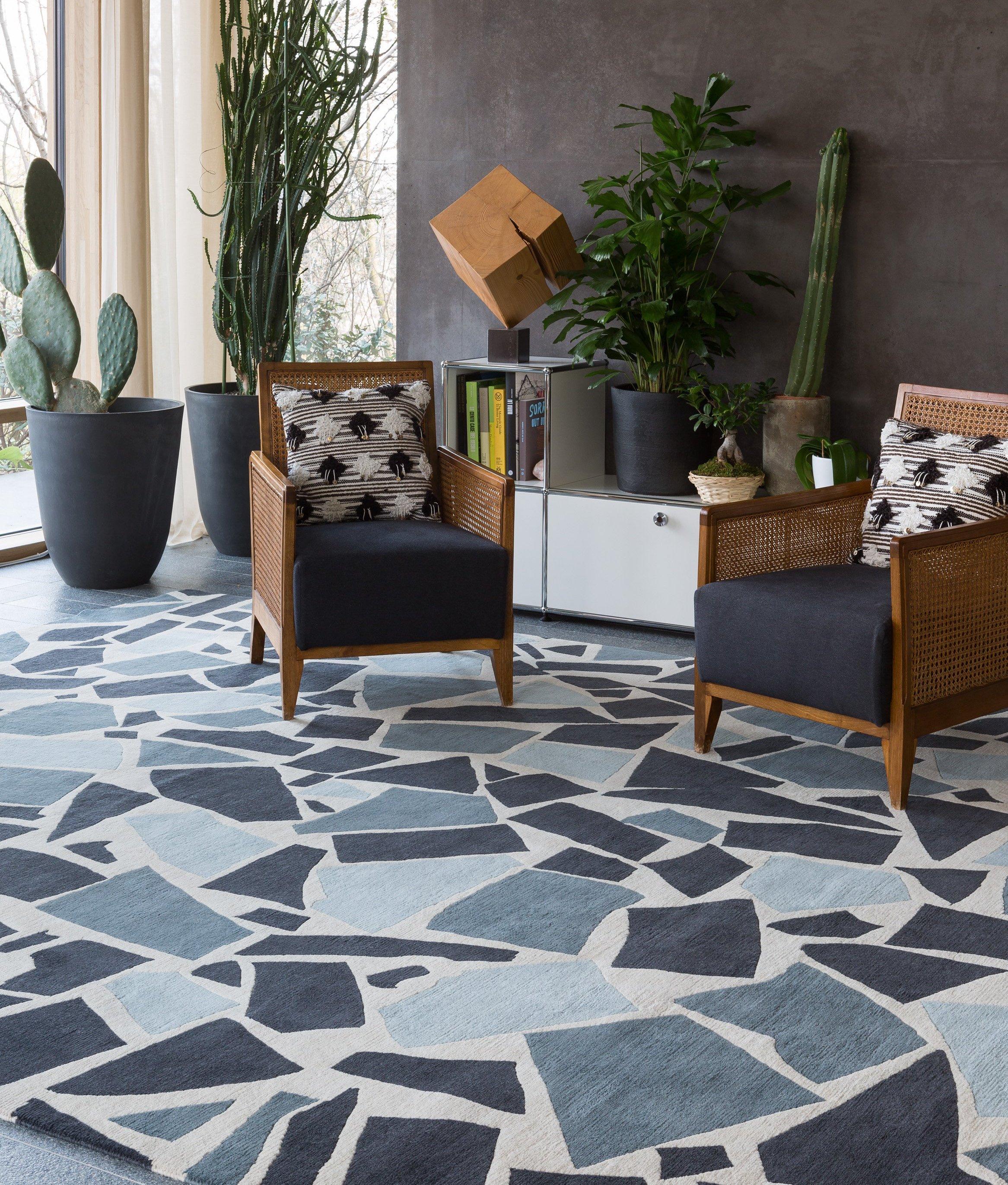 Inspired by 1950s terrazzo floors, this rug design has been given a modern update with a versatile palette of blues and greys on a cream background. The chunkier knot used to create this rug gives it a wonderful texture underfoot and a lower