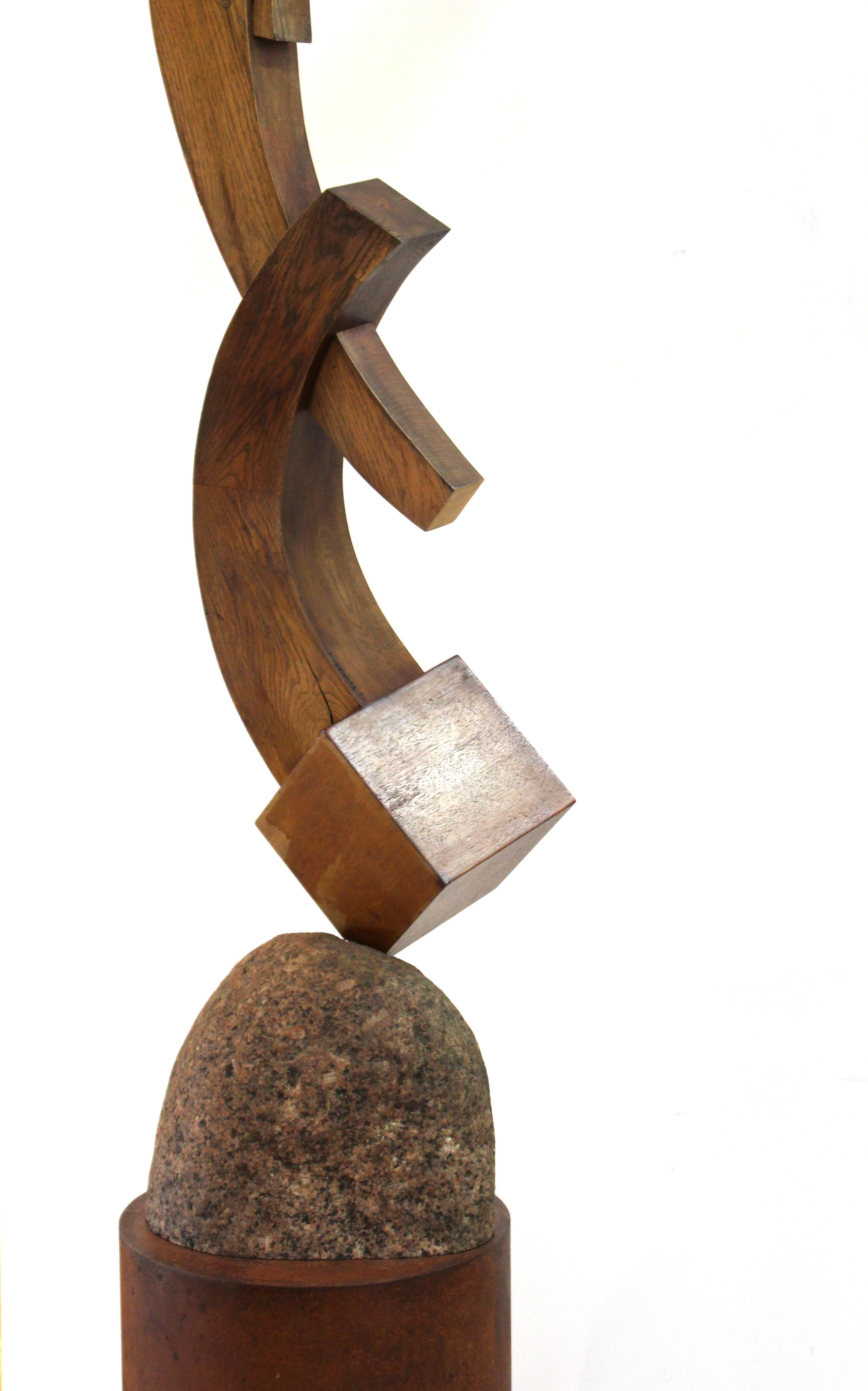 American Postmodern abstract sculpture created by Terrence Karpowicz (American, b. 1948). The Minimalist piece is made with carved and joinery-assembled wood, atop a stone base, mounted on tubular metal column. Signed and dated by the artist on the