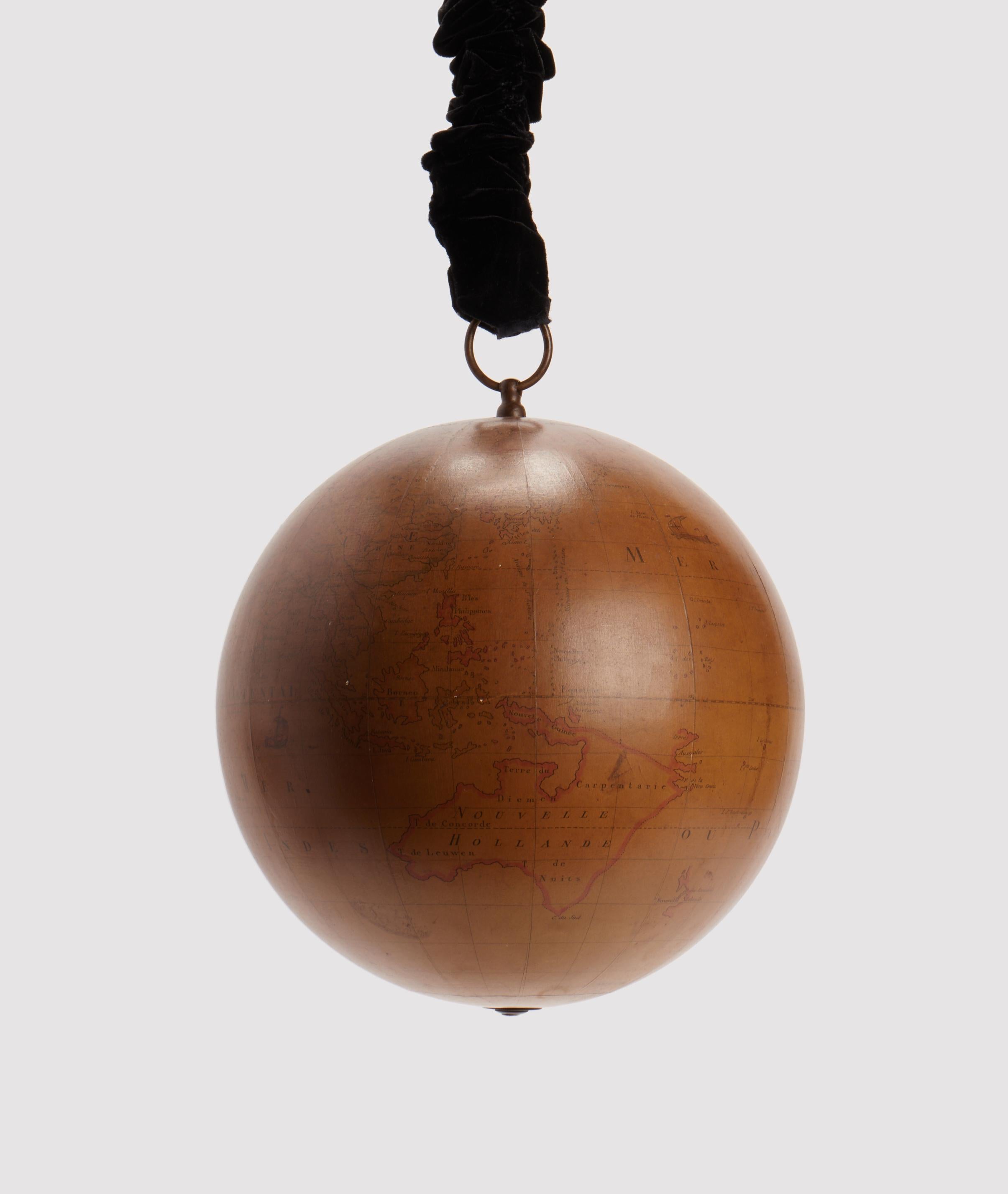 Designed to be hanged to the ceiling, terrestrial  globe, made out of paper machè and wood, brass hook. It is reported in the cartouche of the globe: globe terrestre d’après Mr. Rizzi Zannoni, de la Société Roiale de Gottingue, avec privilege du