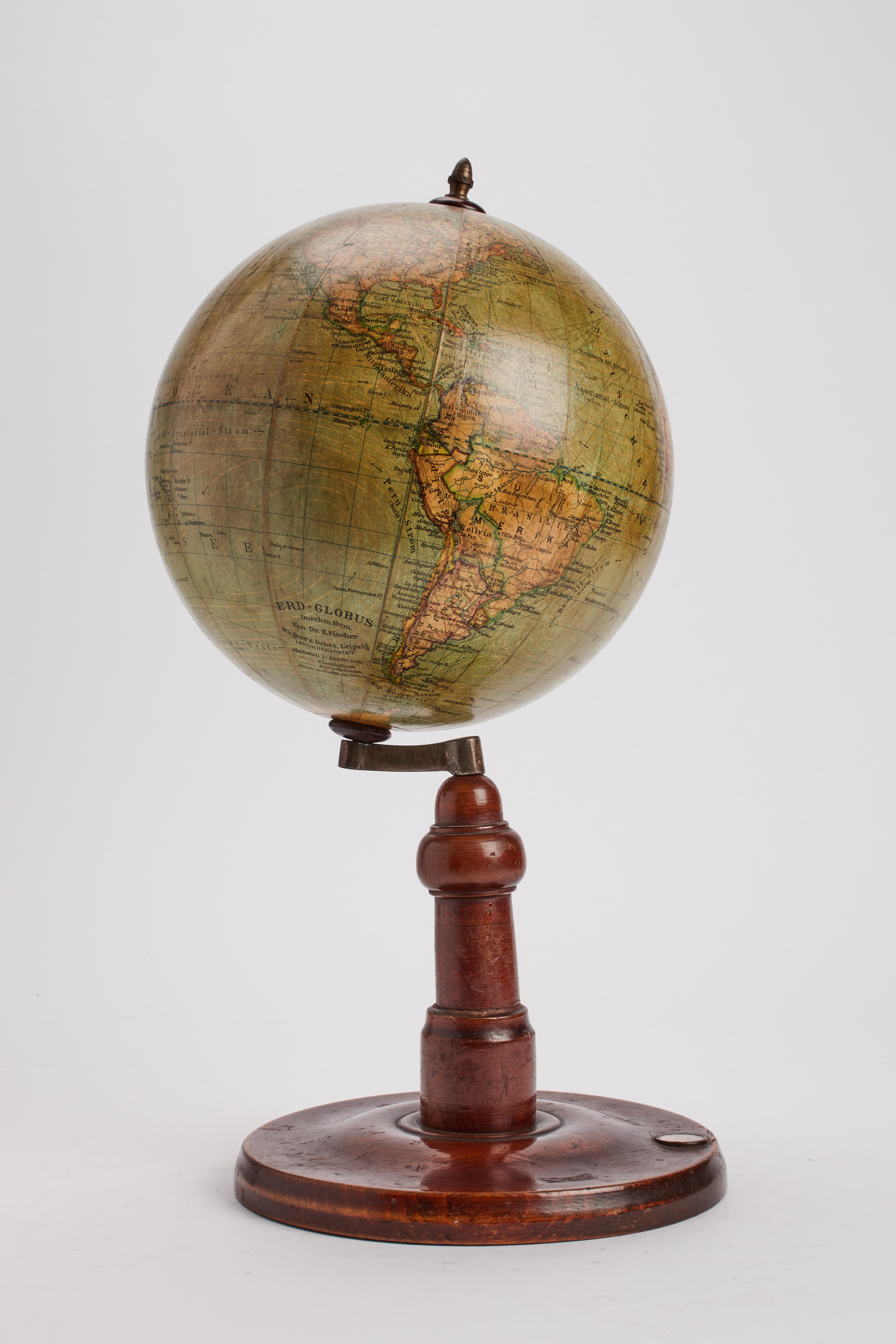 Wheel turned oak wood base, with round foot, moved profile and leg, with original patina. Terrestrial globe, edited by Wagner & Debes, Lipzig. The globe is made out of papier maché, finished with pastiglia ( refined chalk ) and completed by the