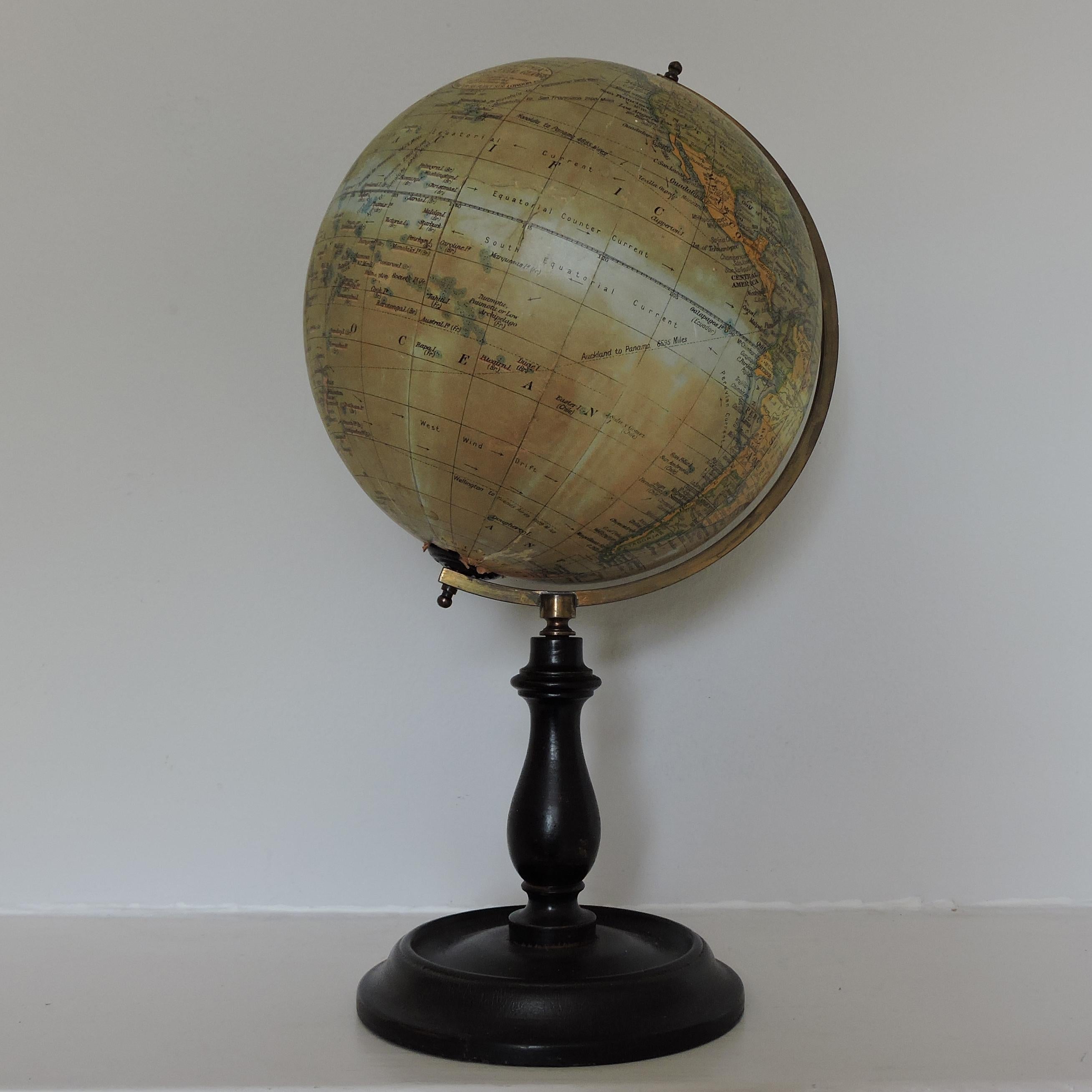 A Geographia terrestrial table globe on an ebonized stand. It turns on a brass half round meridian. It dates from the early 20th century, post 1924 when Petrograd became Leningrad, and pre 1930 as Constantinople is still so named.