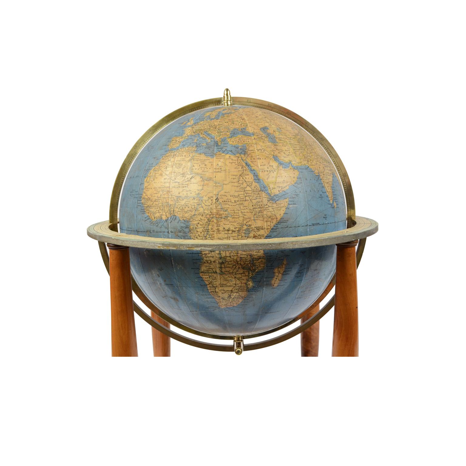 Terrestrial globe published in the 1950s by Vallardi publisher, drawn and engraved by A. Minelli, papier-mâché sphere covered with paper printed by engraving on copper plate and watercolored, walnut base with four feet complete with the circle of