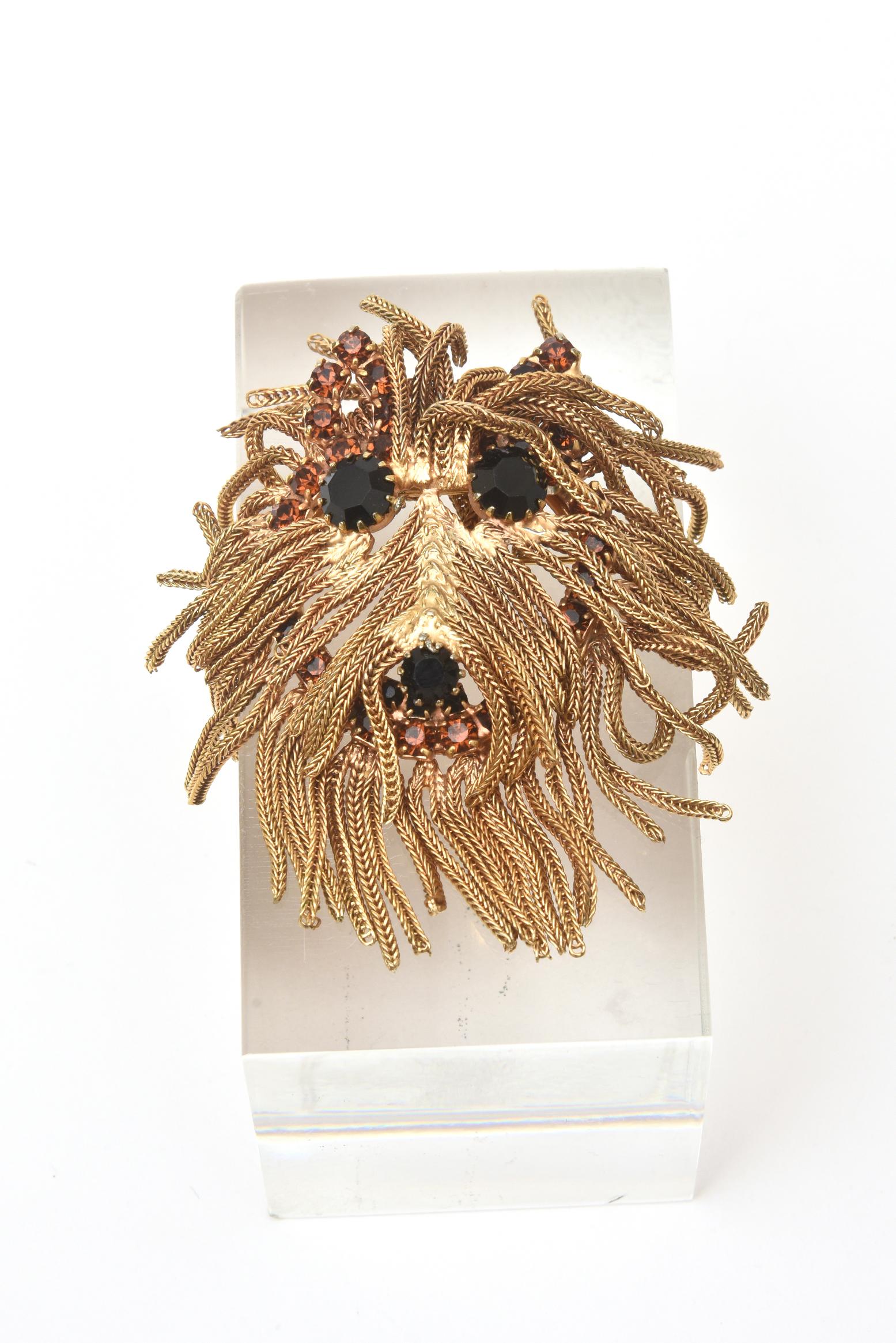 This fabulous gold fringed mane terrier dog head pin brooch and pendant is vintage from the 60's or 70's. It is versatile and definitely an eye catcher. You can wear it as a brooch or pendant. The prong set rhinestones are two different colors; one