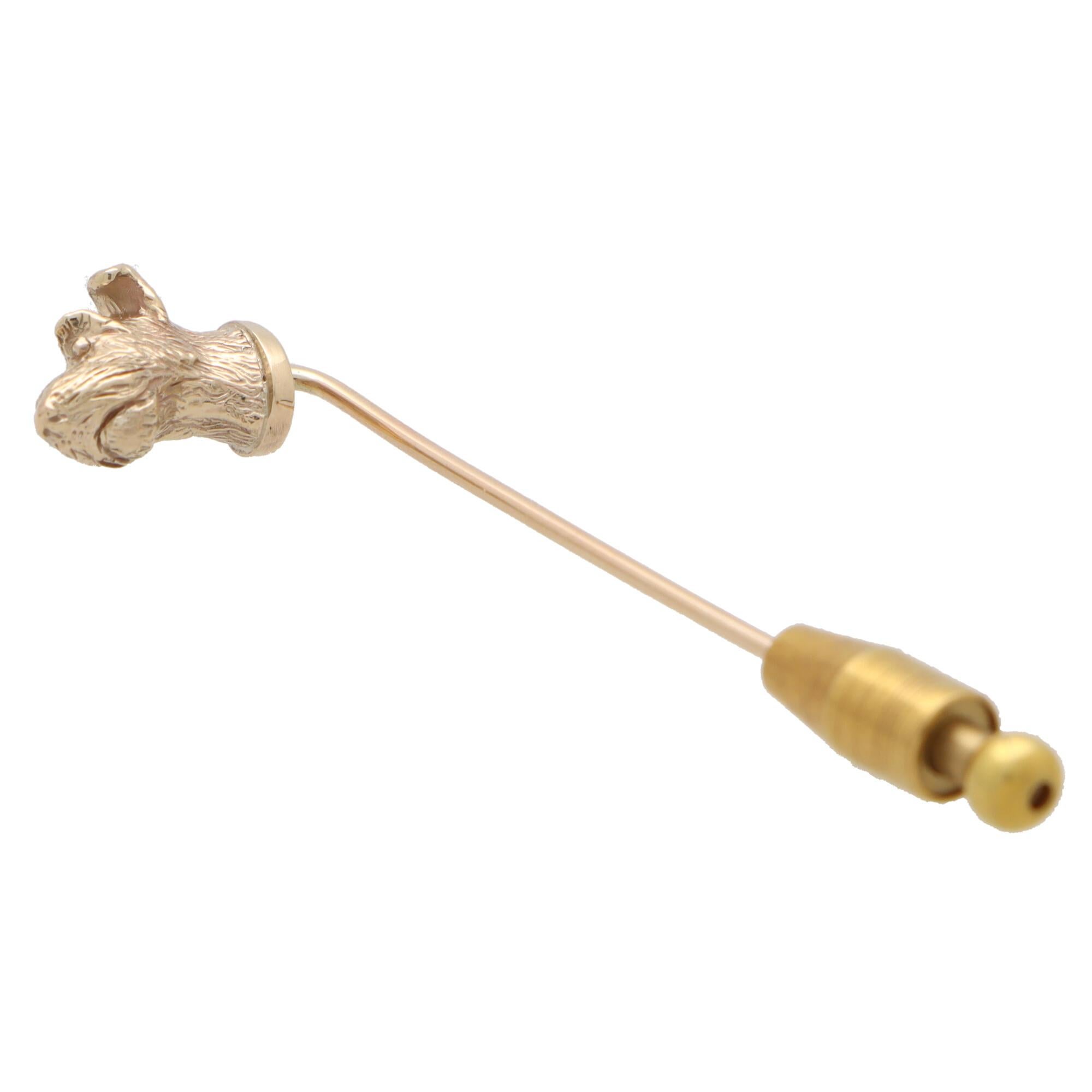 A lovely solid gold Terrier dog head stick pin set in 9k yellow gold. 

The stick pin solely features a beautiful terrier head which sits proudly on a classic stick pin fitting. The terrier has been intricately hand detailed so that the wearer can