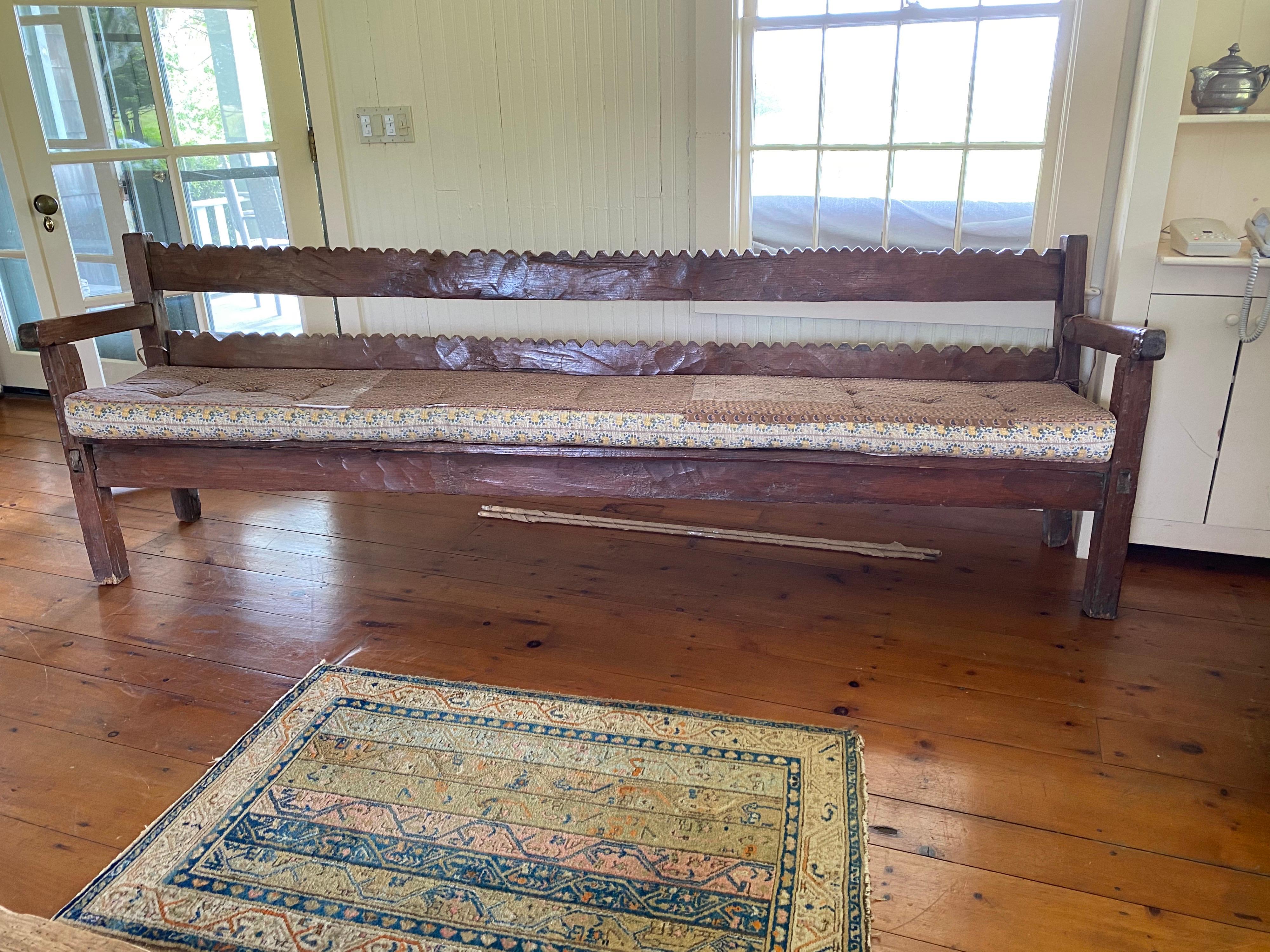 A terrific extra long rustic bench
This bench is hand carved and exceptionally long. Each zig zag has been cut by hand with irregularities adding to the overall charm of the piece. Structurally sound though areas of separation. There is a gap in
