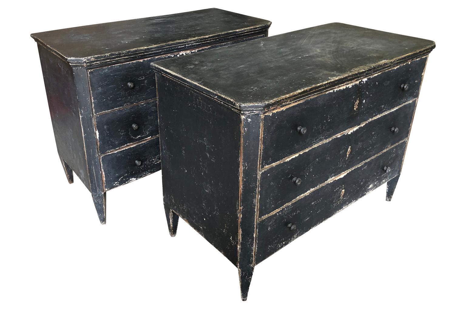A sensational pair of late 19th century painted commodes from Spain. Great construction with three drawers over tapered legs and edge finish to the top. The painted finish is wonderful with great texture. Great as bedside cabinets or converted into