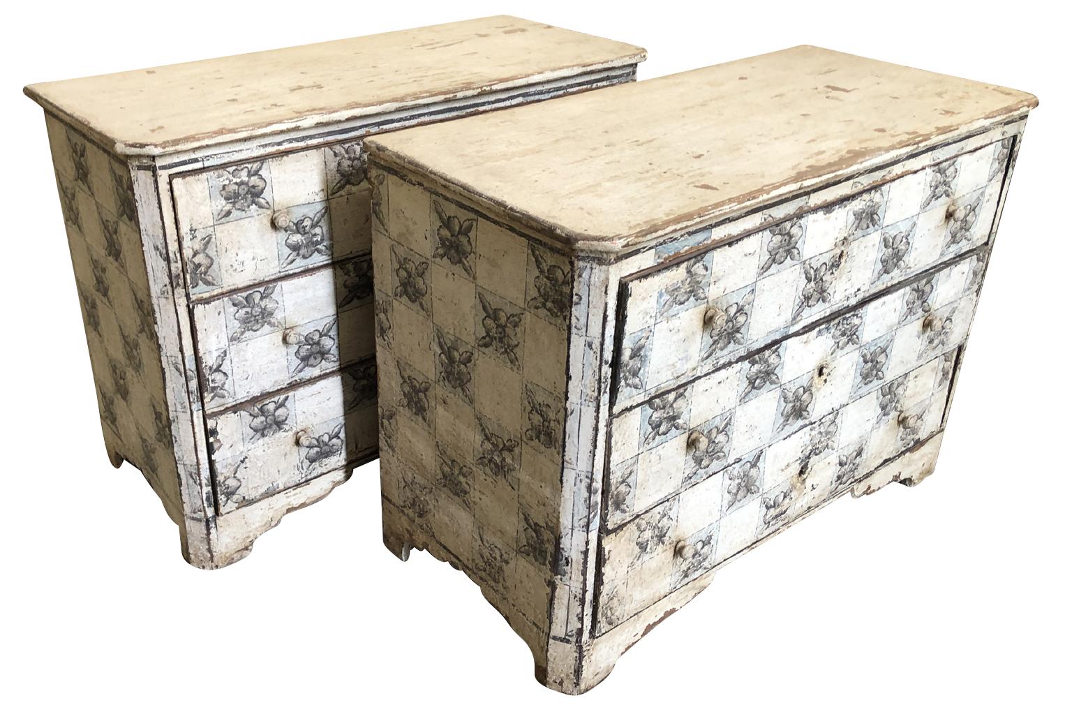 A sensational pair of late 19th century painted commodes from Spain. Great construction with three drawers over bracket feet. The painted finish is wonderful with a great motif and texture. Great as bedside cabinets or converted into vanities. One