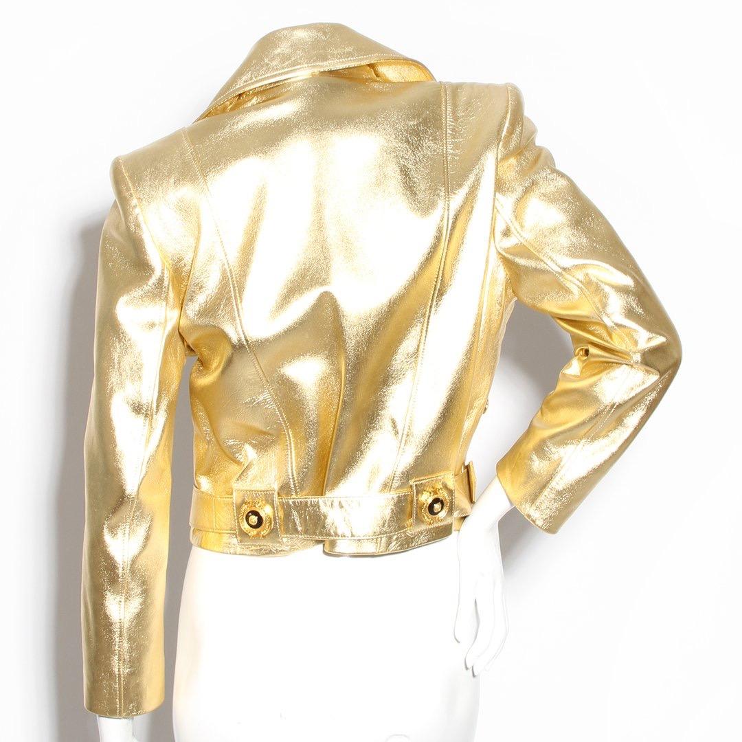 Gold motorcycle jacket by Terry
Leather crop jacket 
Gold metallic color 
Notched collar 
Asymmetrical front zip closure 
Two front zip pockets 
Waist buckle design 
Slight shoulder pads 
Black and goldtone hardware
Made in France
Condition: Great,
