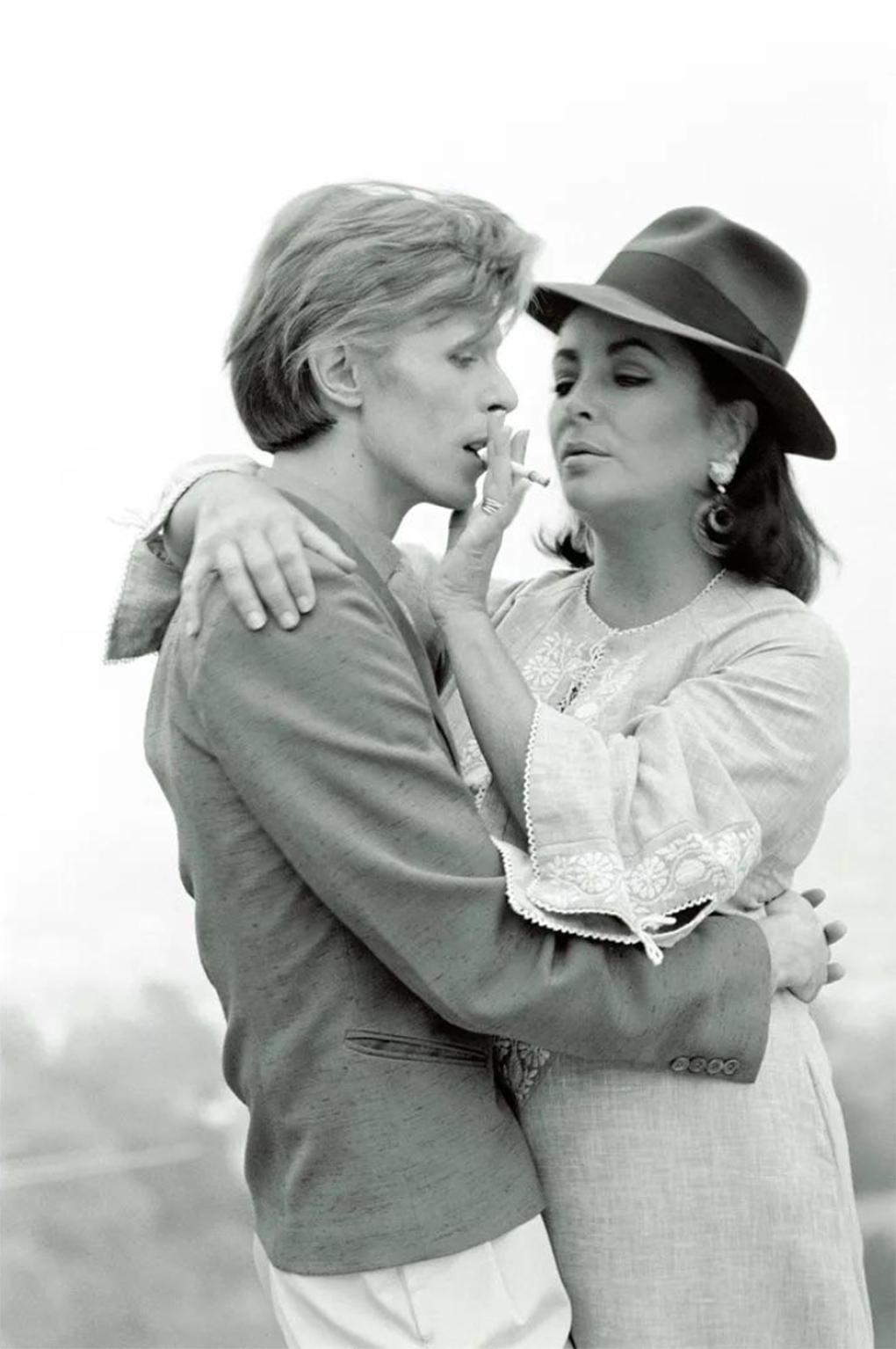 Seltener, signierter Künstlerabzug von David Bowie und Elizabeth Taylor von Terry O'Neill

David Bowie und die Schauspielerin Elizabeth Taylor treffen sich zum ersten Mal im Haus von George Cukor in Beverly Hills, 1974. 

12x16" Silbergelatineabzug,