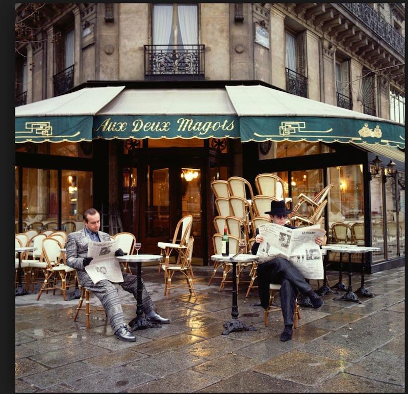 Terry O'Neill Color Photograph - Elton John and Bernie Taupin sitting outside Aux Deux Magots