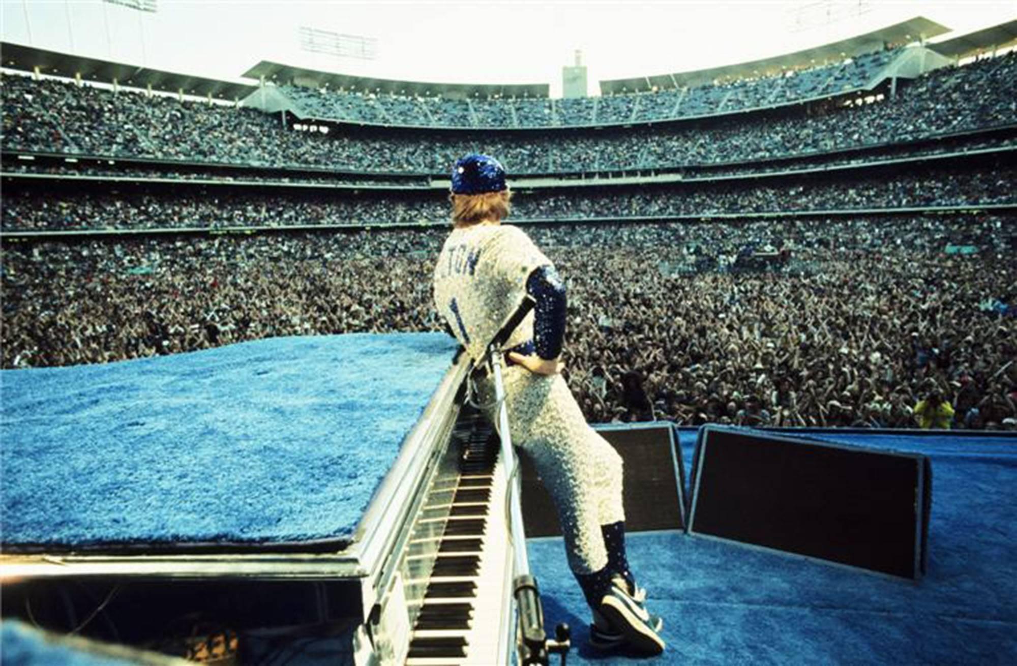Terry O'Neill Color Photograph - Elton John At Dodger Stadium, Back View, Custom Framed 