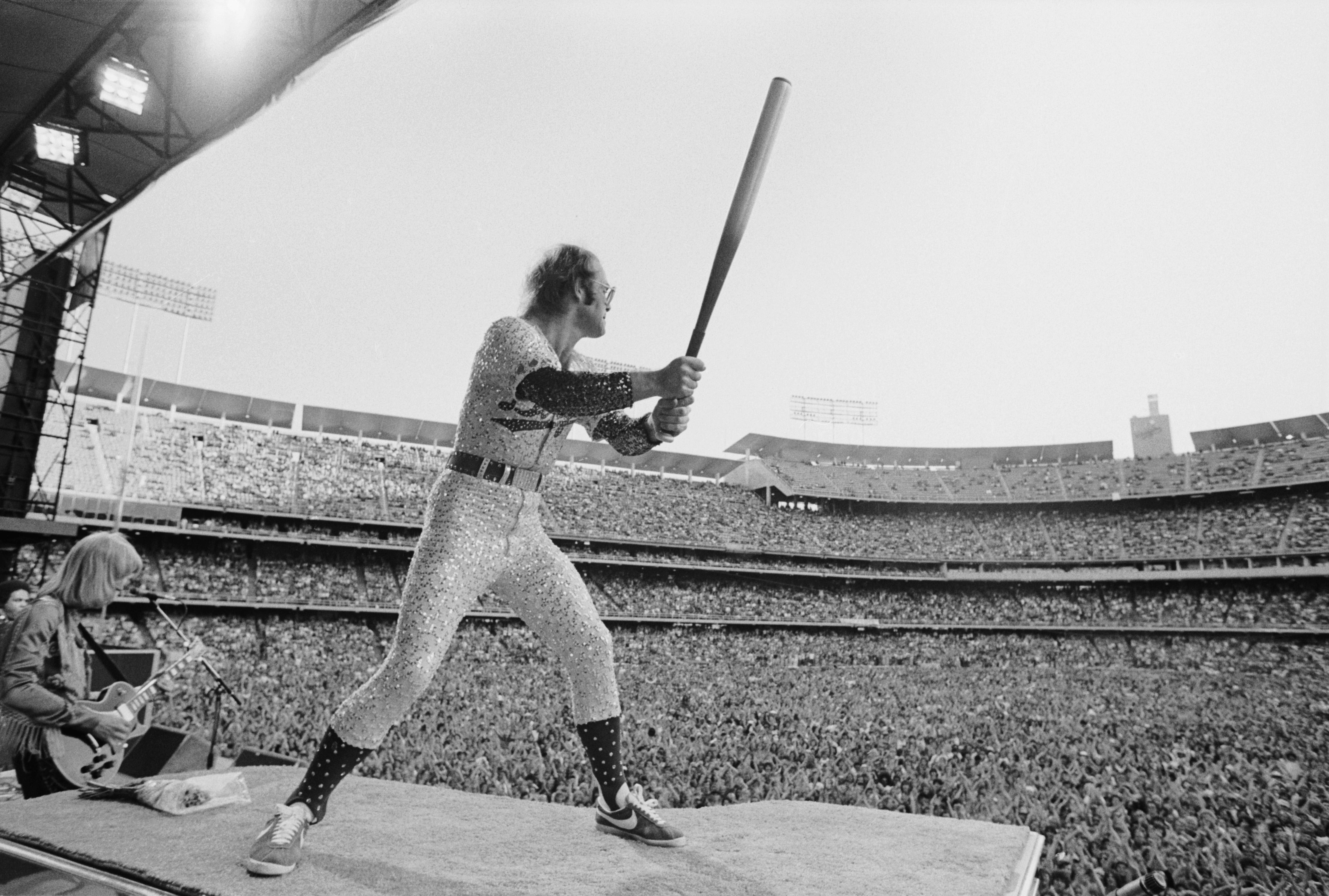 Elton John in Full Swing, Dodger Stadium, Los Angeles, 1975 - Terry O'Neill
Signed and numbered
Silver gelatin print

Available in the following sizes:
12 x 16 inches, edition of 50 + 10 APs
16 x 20 inches, edition of 50 + 10 APs
20 x 24 inches,