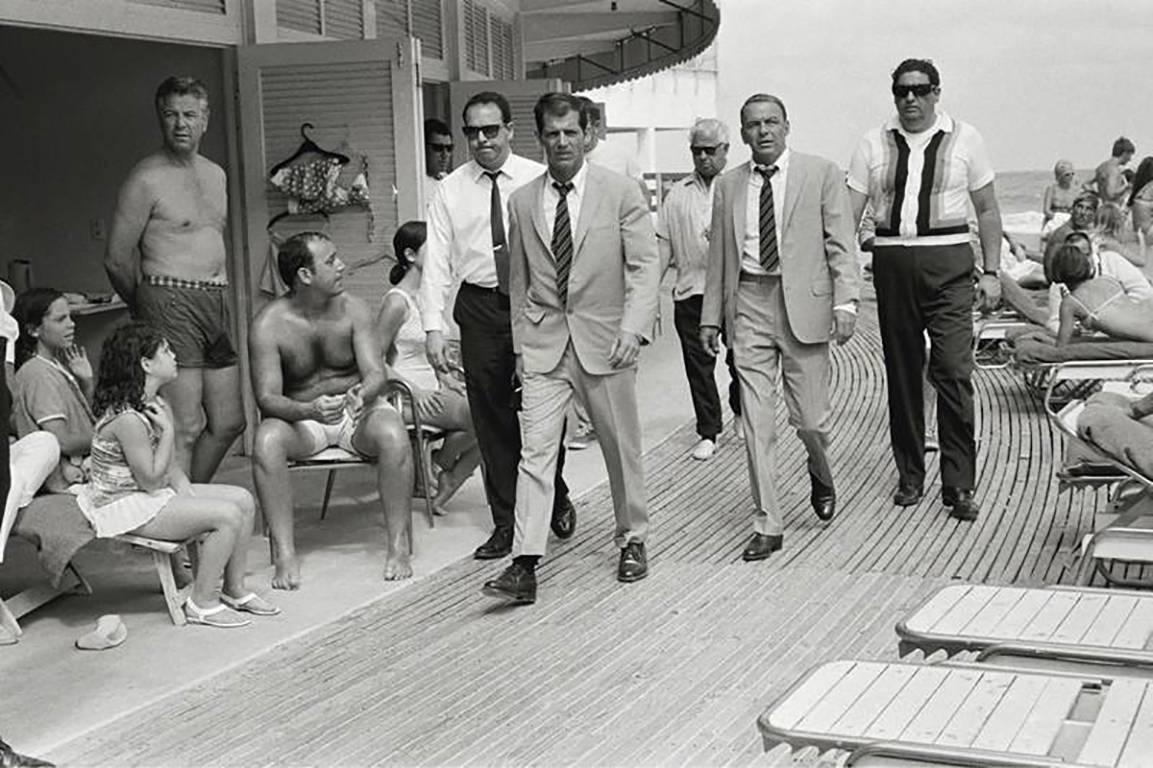 Terry O'Neill Black and White Photograph - Frank Sinatra with Body Double and Security Team, Boardwalk, Miami Beach, 1967