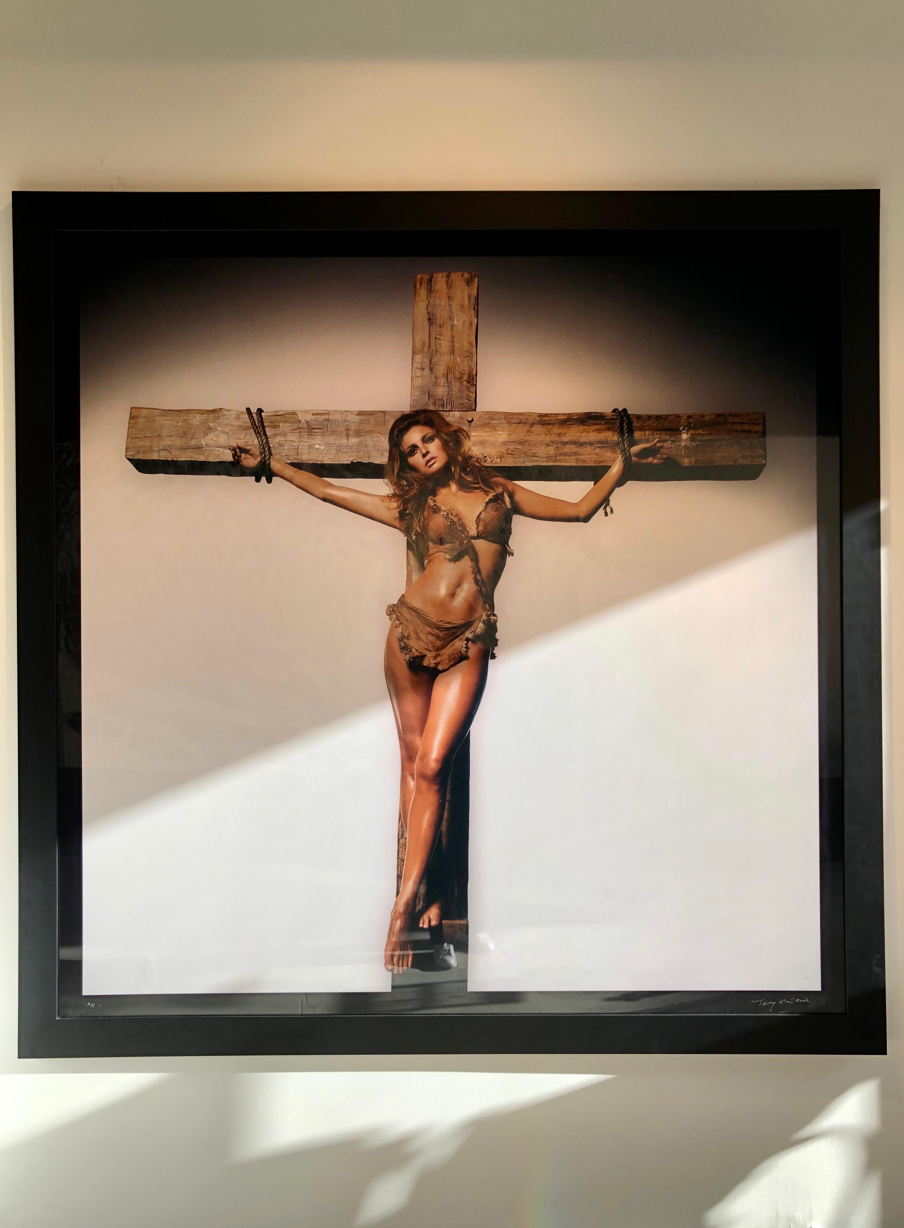 Raquel Welch on Cross - Photograph by Terry O'Neill