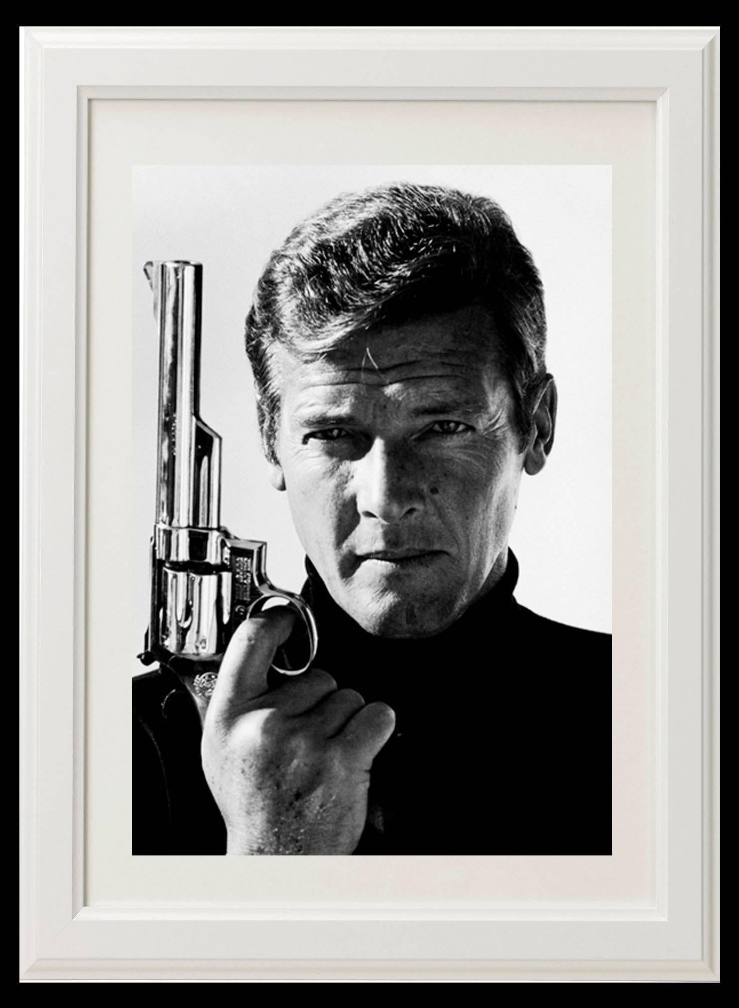Roger Moore as Bond 007 with a 357 Magnum, ‘Live and Let Die’, 1973 - Print by Terry O'Neill