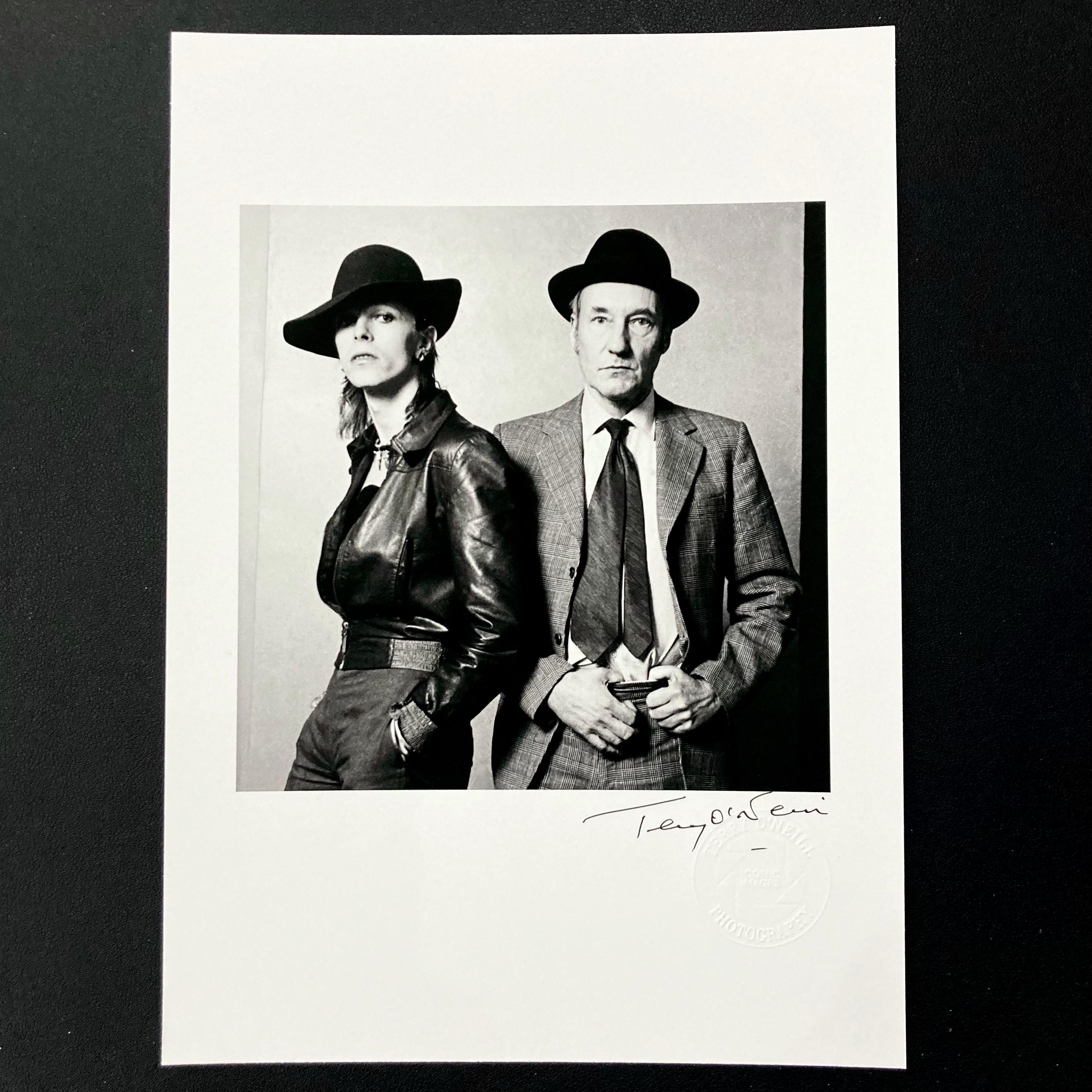 Set of two, signed open edition, 8” x 10” archival prints by Terry O'Neill, featuring Terry O’Neill’s embossed studio stamp

One print features Bowie with author, William Burroughs, the other with actress, Elizabeth Taylor. Both were taken in 1974.