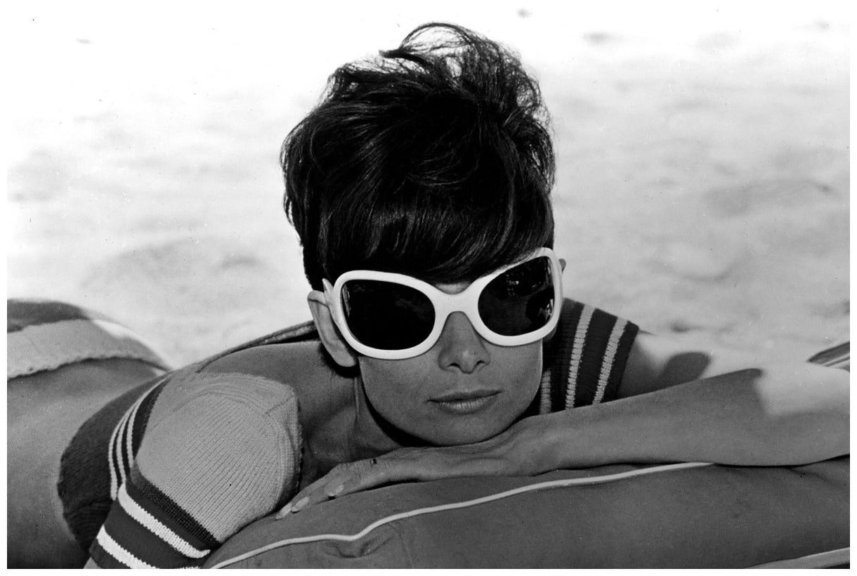 Audrey Hepburn Relaxing, 1970
Silver gelatin print
Estate stamped and numbered edition of 50

Audrey Hepburn relaxing on the beach in St. Tropez, France while on location for the film Two for the Road, 1966.

Terry O'Neill (born 1938; London, UK) is