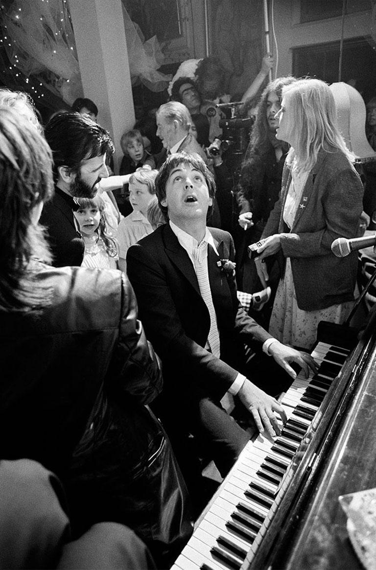 Paul McCartney at Ringo Starr’s Wedding, 1961
Silver gelatin print
40 x 30 inches
Estate signature stamped numbered edition of 50

Paul McCartney plays the piano at the Ringo Starr’s wedding to Barbara Bach at the London club Rags, 1981. Ringo can