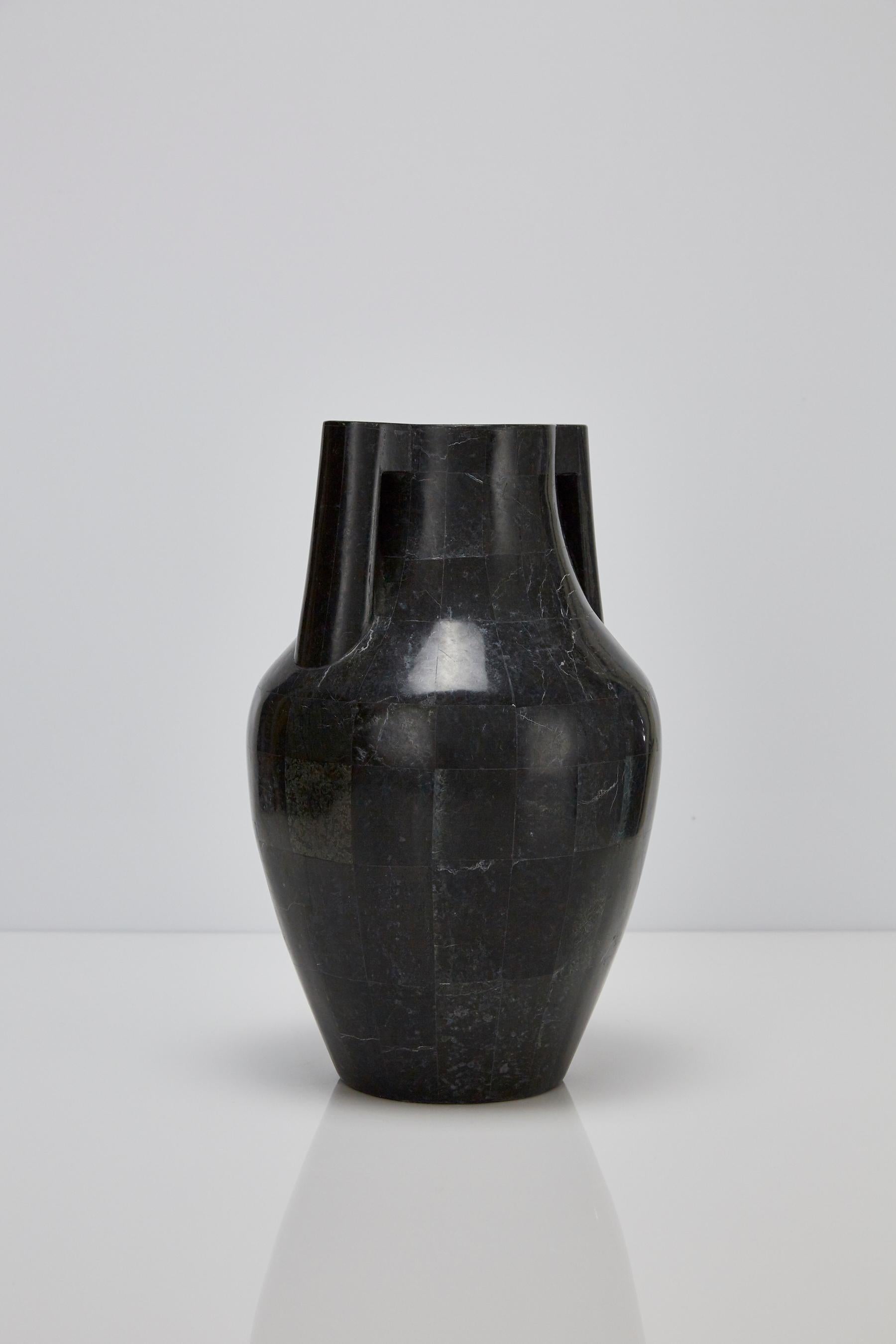 Tall vase styled in the form of a Mesopotamian water jug. Body of vase executed in fiberglass with inlaid black stone over the exterior.

Pair available.