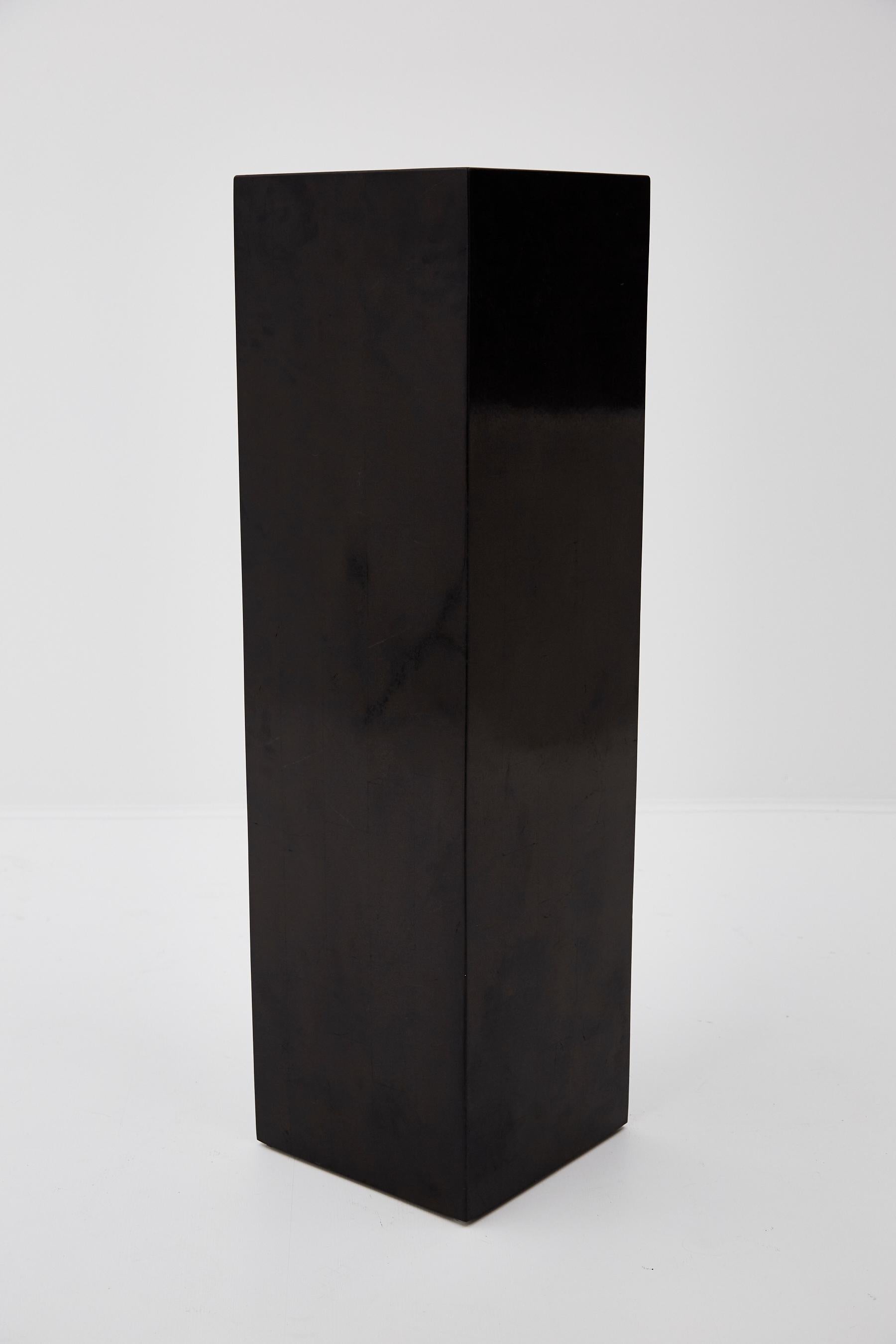 Black tessellated stone square pedestal. 

Measures: 42 inches tall.