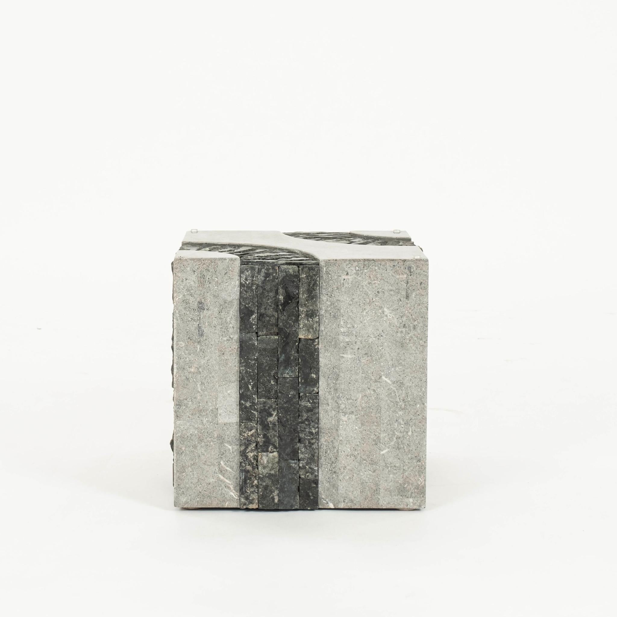 20th Century honed  grey white stone (possibly granite) cube side table banded up and over with rough cut edges in black.