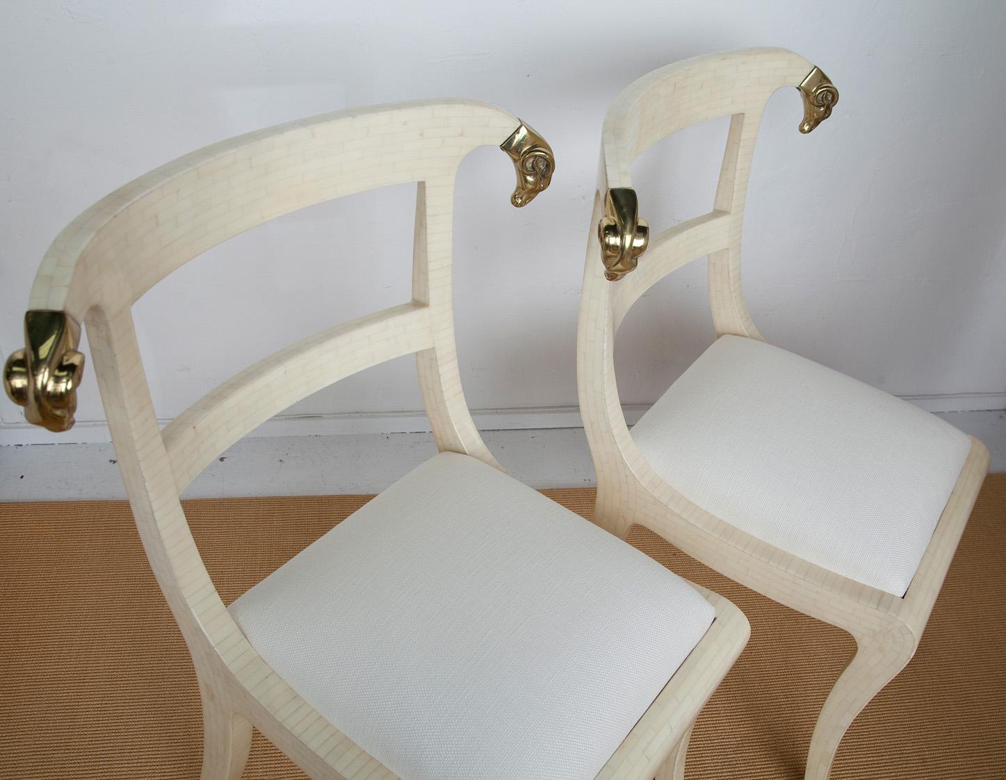 Tessellated bone gives these circa 1980's Enrique Garces Neoclassical side chairs with brass rams heads a fresh modern spin. Upholstered in cream linen, we imagine these as a pair placed on either side of a fireplace or sideboard, or purchased