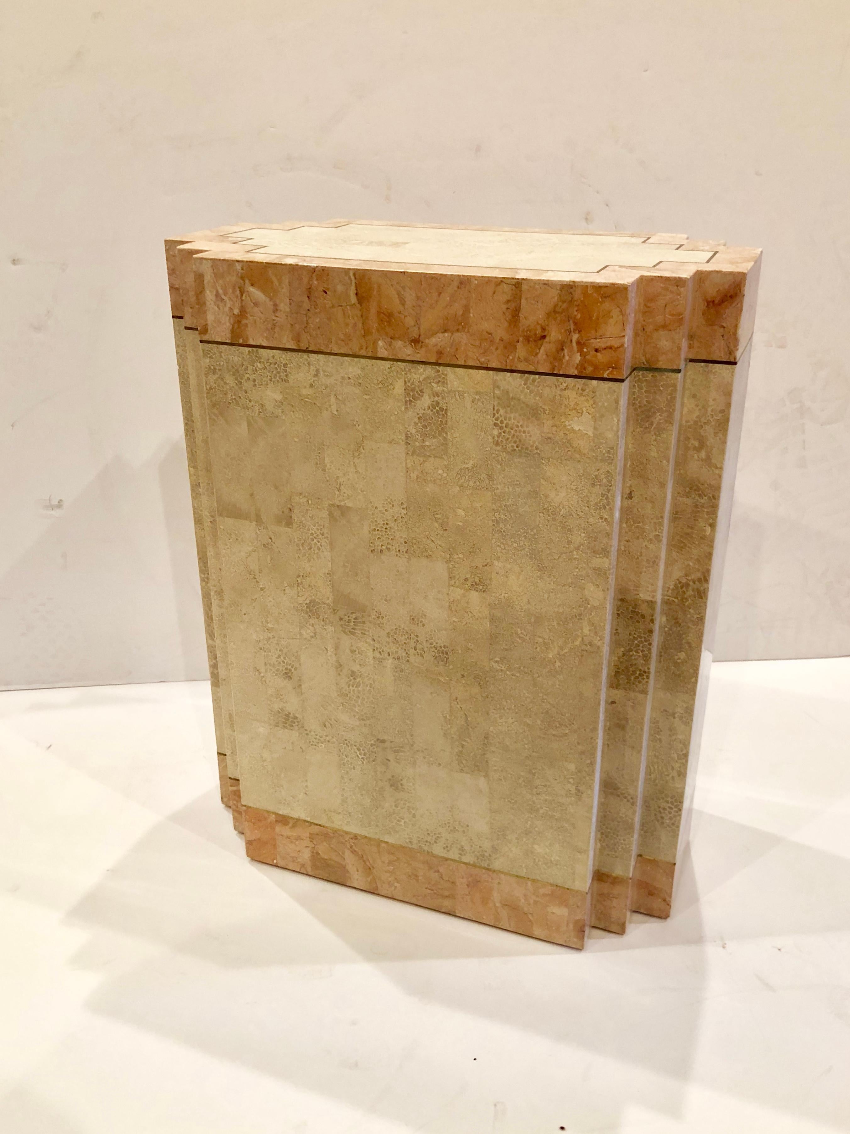 Tessellated and polished fossil stone pedestal Dinning table Base designed by Robert Marcius for Casa Bique, features a recessed base and a brass inlaid top and a brass ring bottom it could also be used as a dinning table. With a glass top, in very