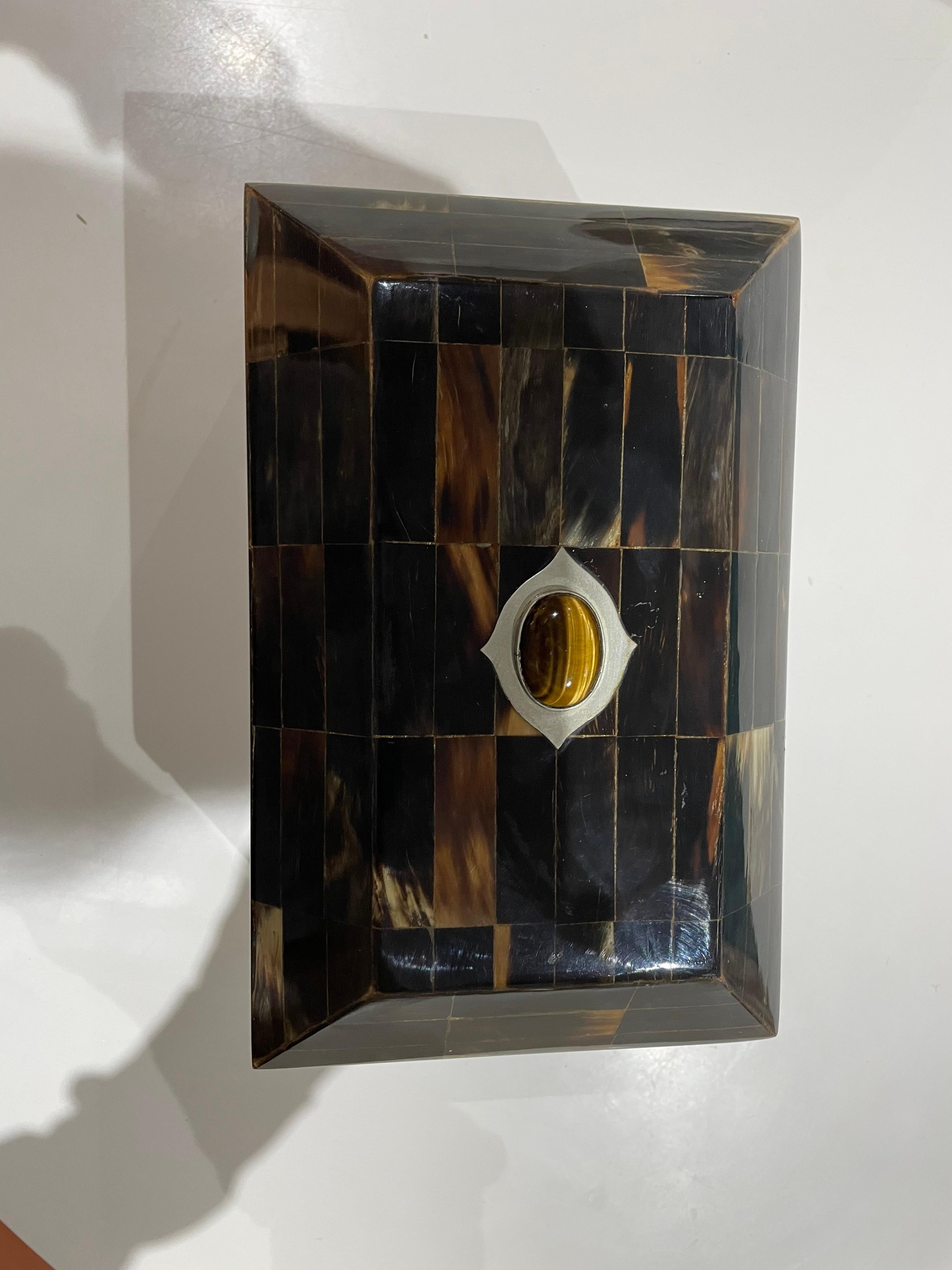 This is a wonderful tesselated horn box with a sterling and tigers eye adornment on top of box would make a beautiful piece in any ones home.