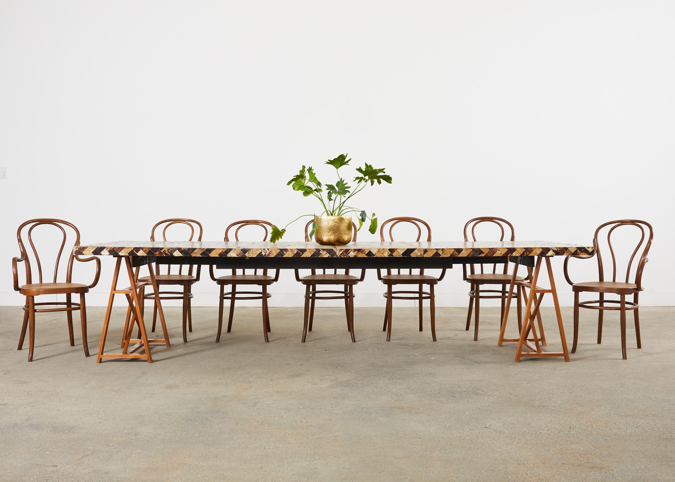 Dramatic extending dining table with two leaves produced in the 70s in Colombia by William Piedrahita for Thomas Britt. The table features a horn veneered top and sides in a stylish chevron style pattern. The table measures 84 inches wide and 126