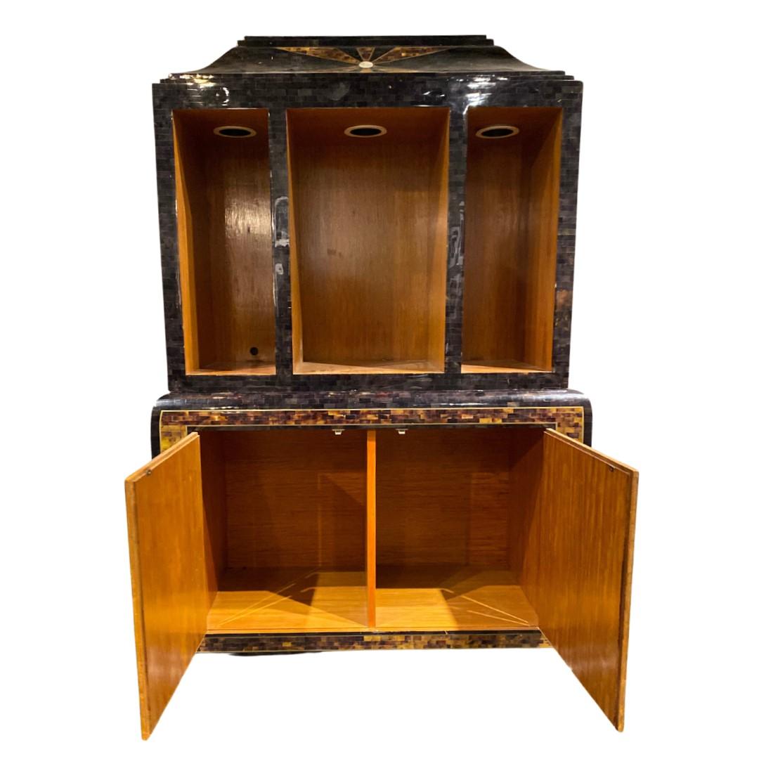 Very unique display cabinet. 
Features 3 lighted display sections across the top & 2 cupboard doors on the base.
Tessellated Horn, Tessellated Mother-of-Pearl, & Brass Inlay over Wood.
This unit is 2 pieces that sit on top of each other.
There are a